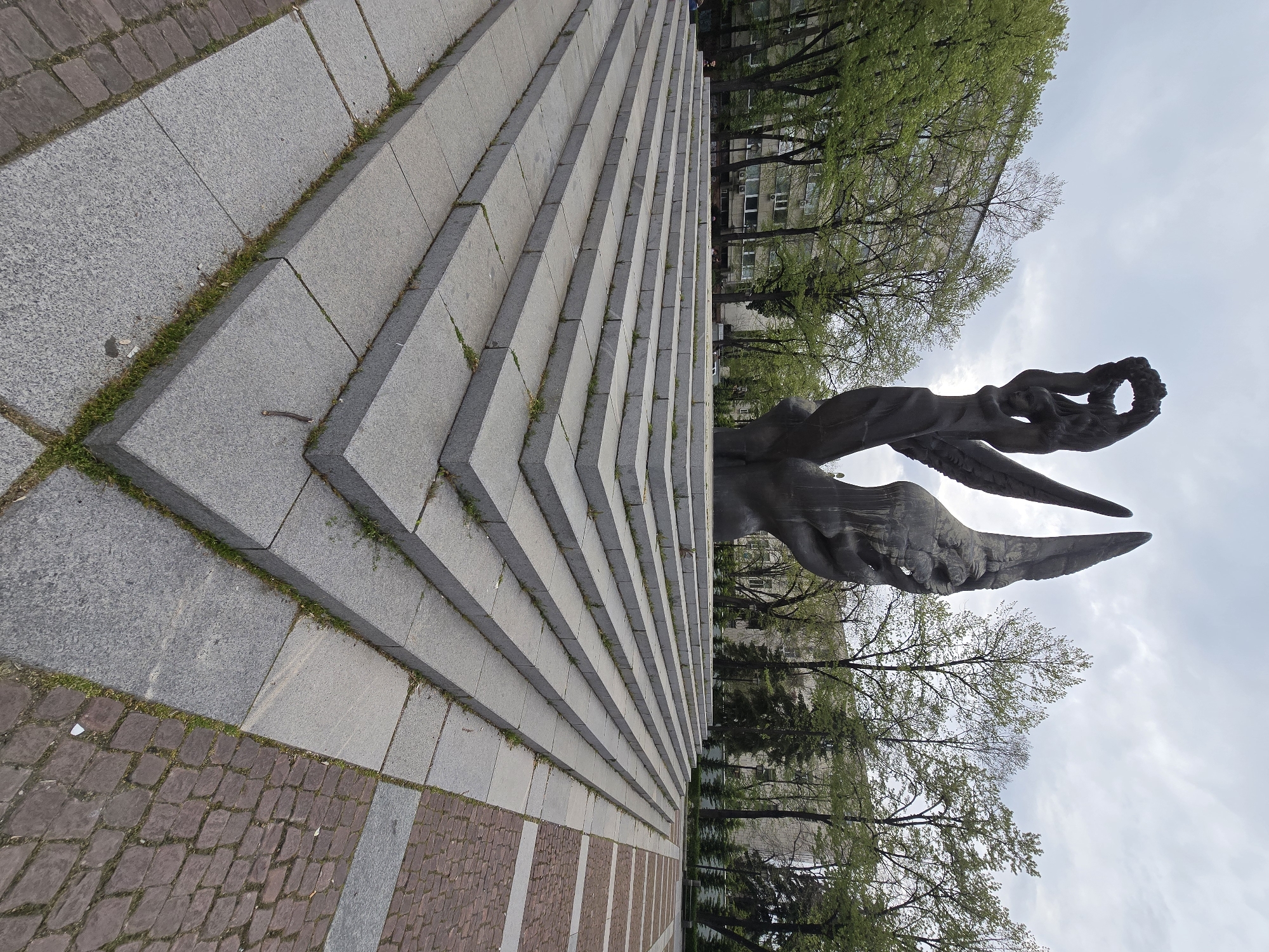 Bronze monuments and Cyrillic signage documented in urban setting