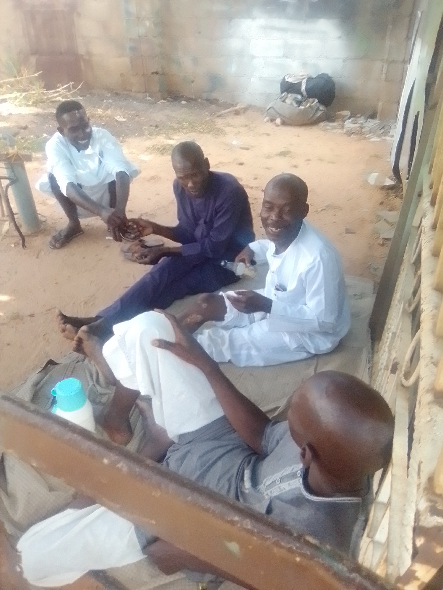 Morning gathering and motorcycle work in Pantame, Nigeria