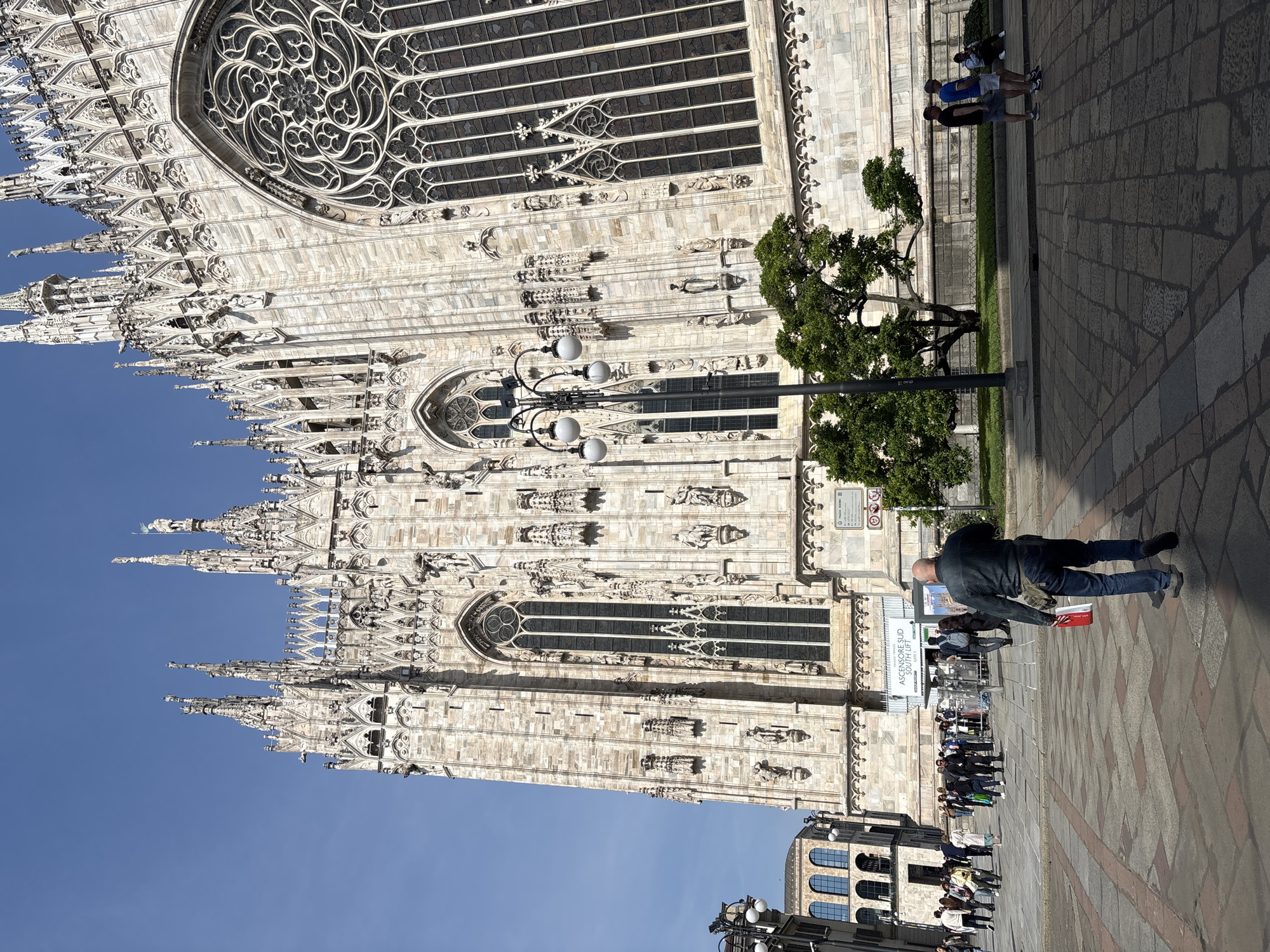 Tourist documents Milan Cathedral architecture from multiple angles