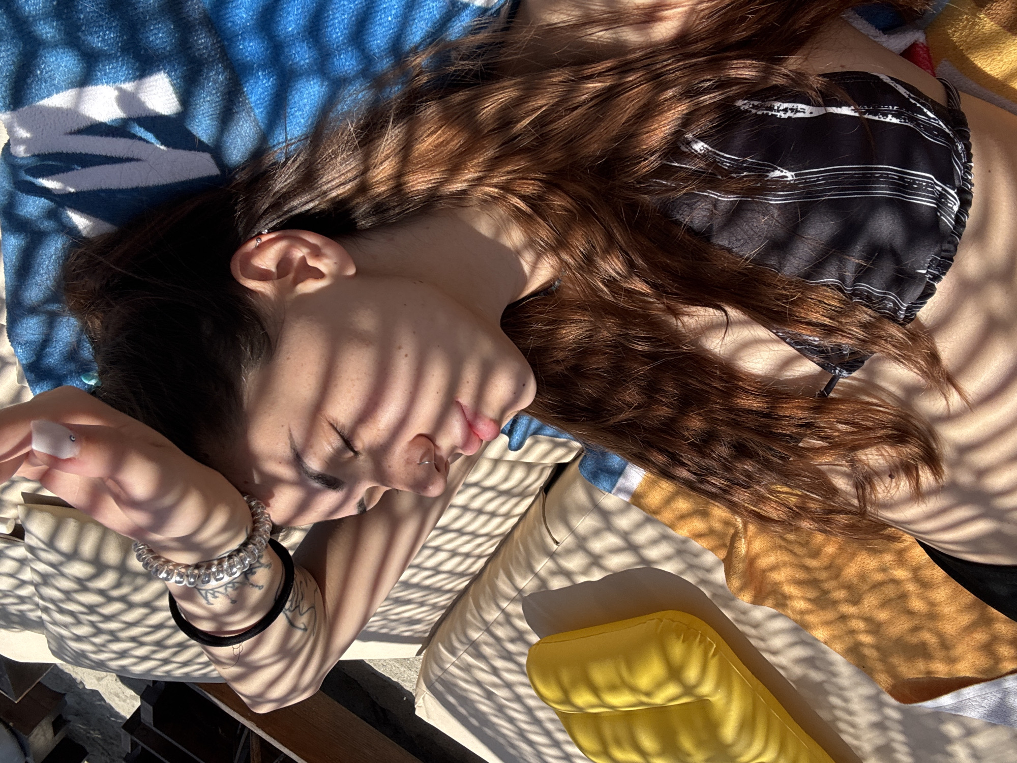 Woman enjoys beach morning with henna tattoos in Greece