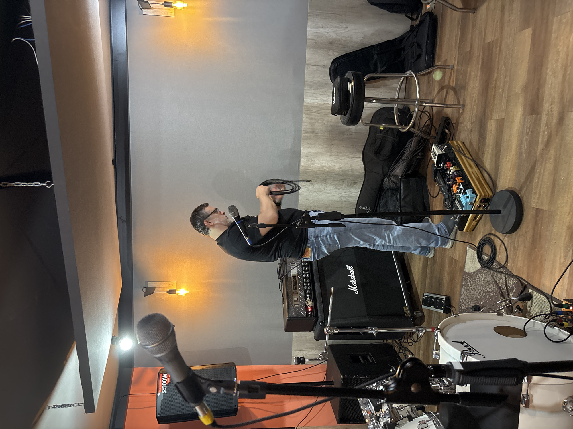 Musicians set up for band practice in São Paulo studio