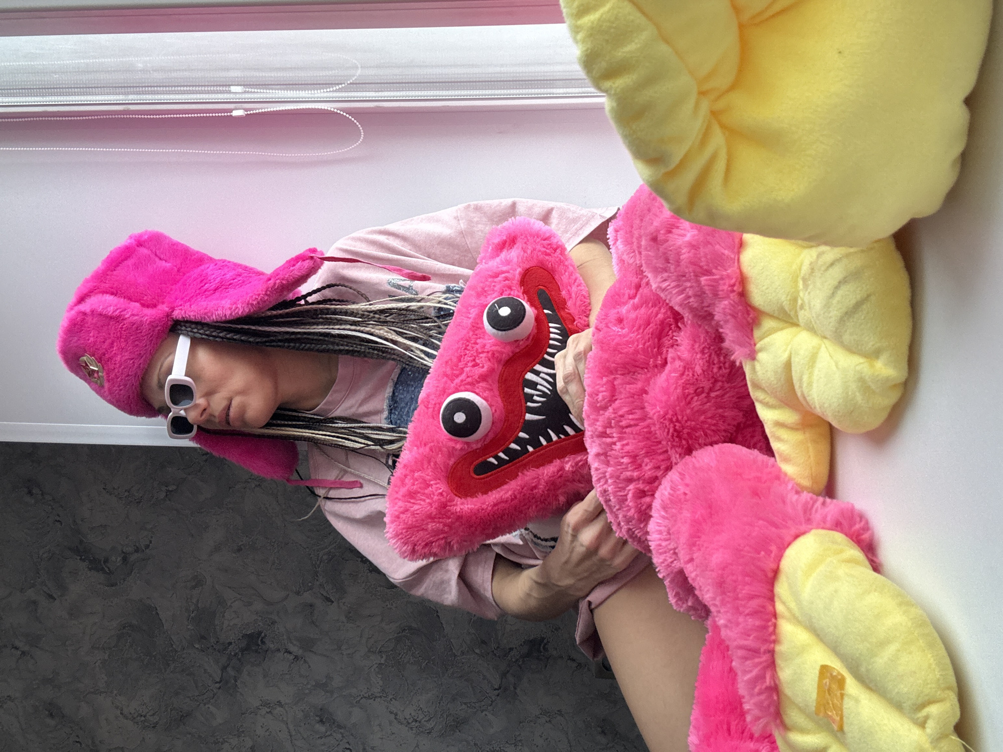 Person displays colorful plush toys in Rusanovo, Russia