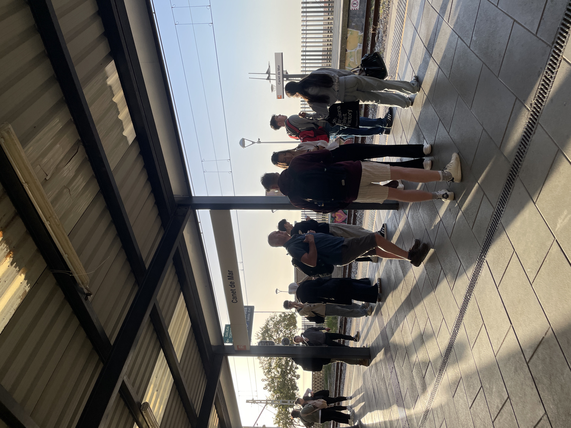 Morning commuters wait at Canet de Mar train station