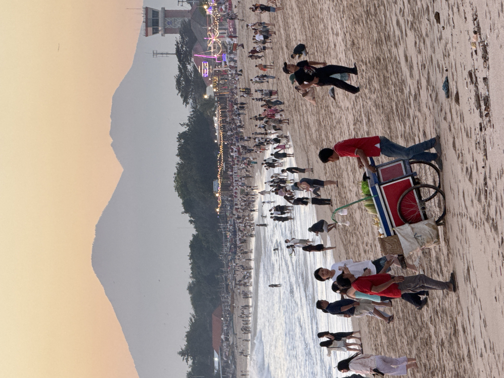 Tourists gather for sunset photography at Kuta Beach