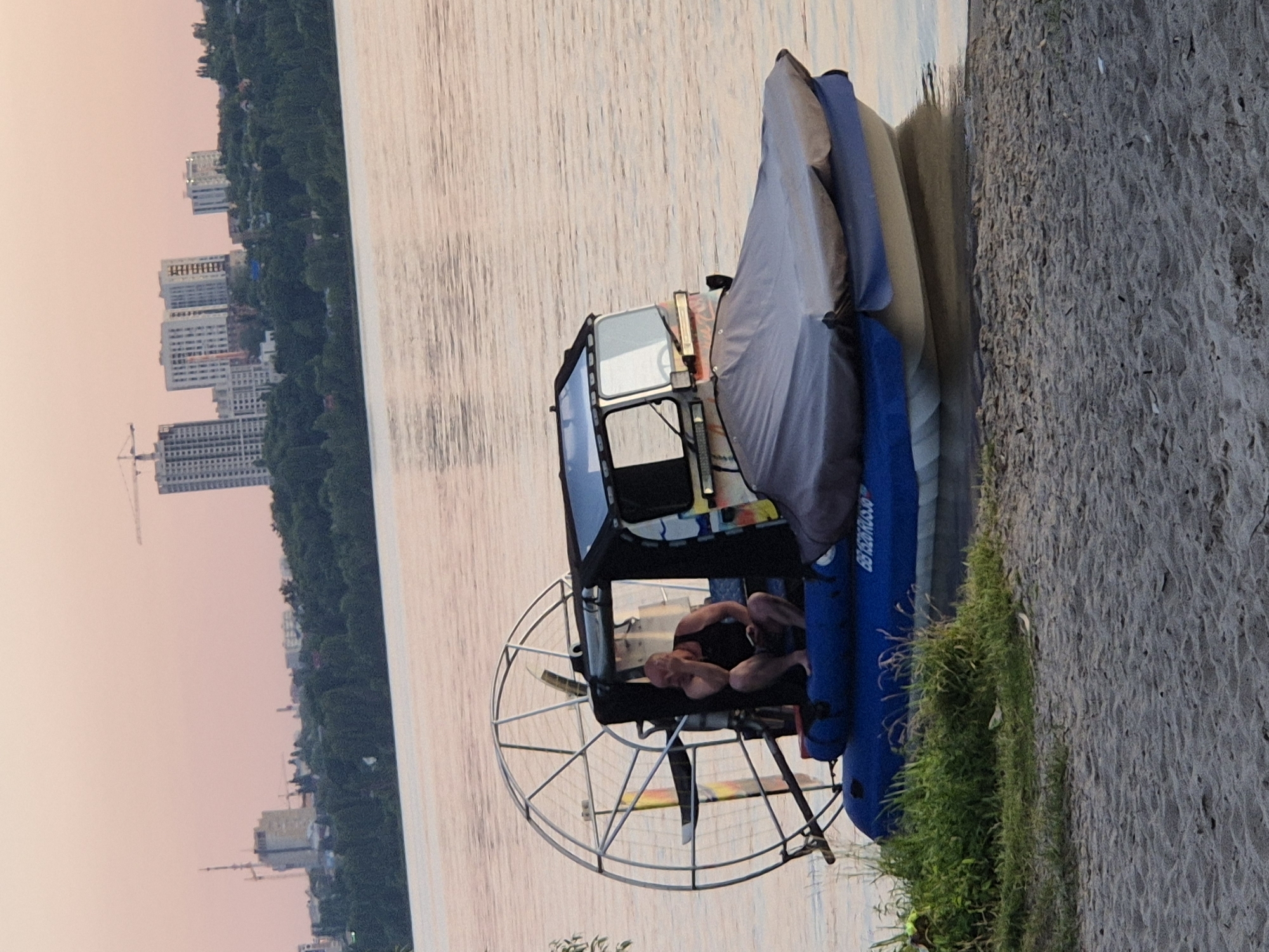 Beach hangout and active construction site at Voronezh sunset