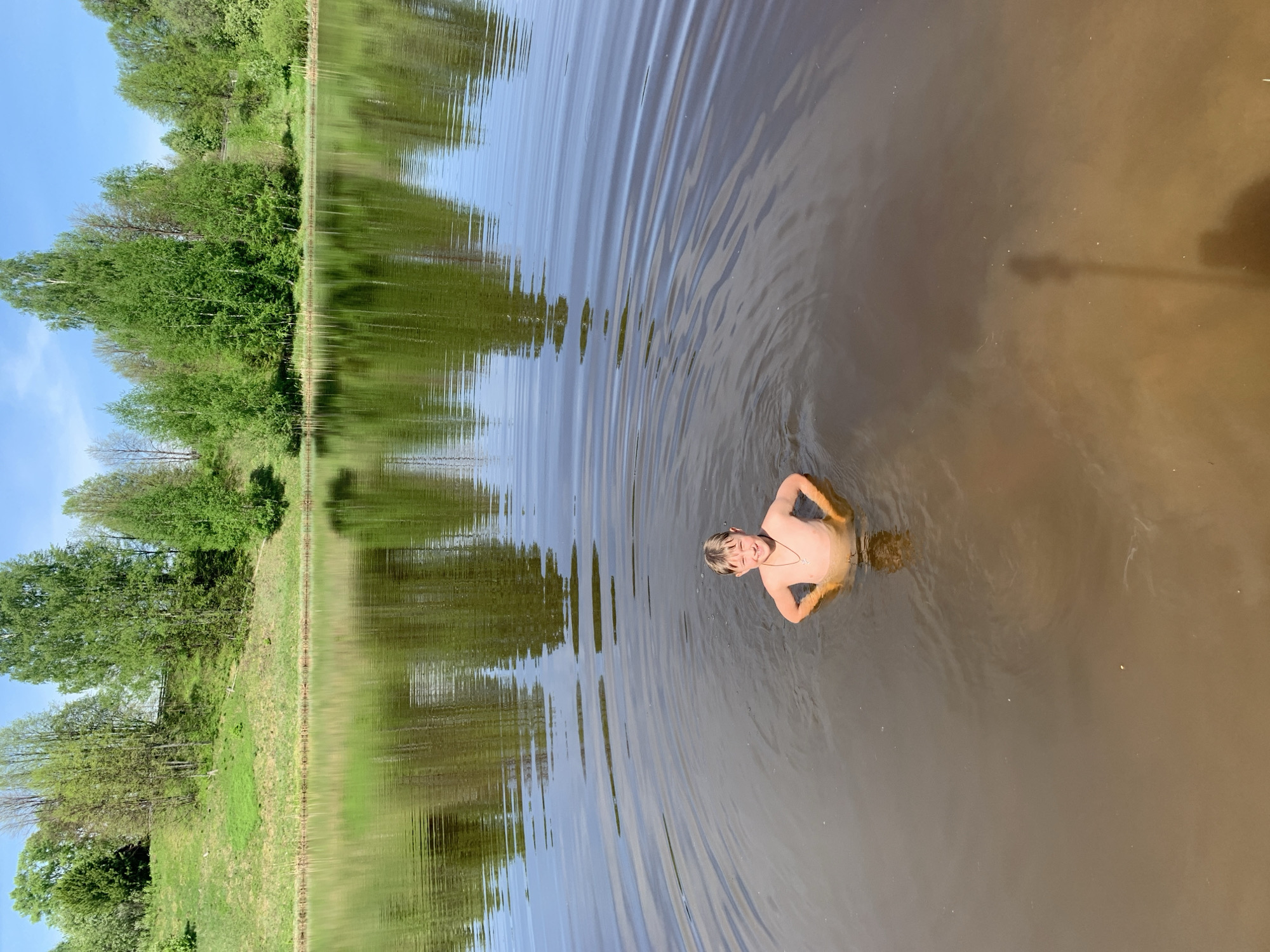 Swimmers enjoy murky waters in Zasechnyi, Russia
