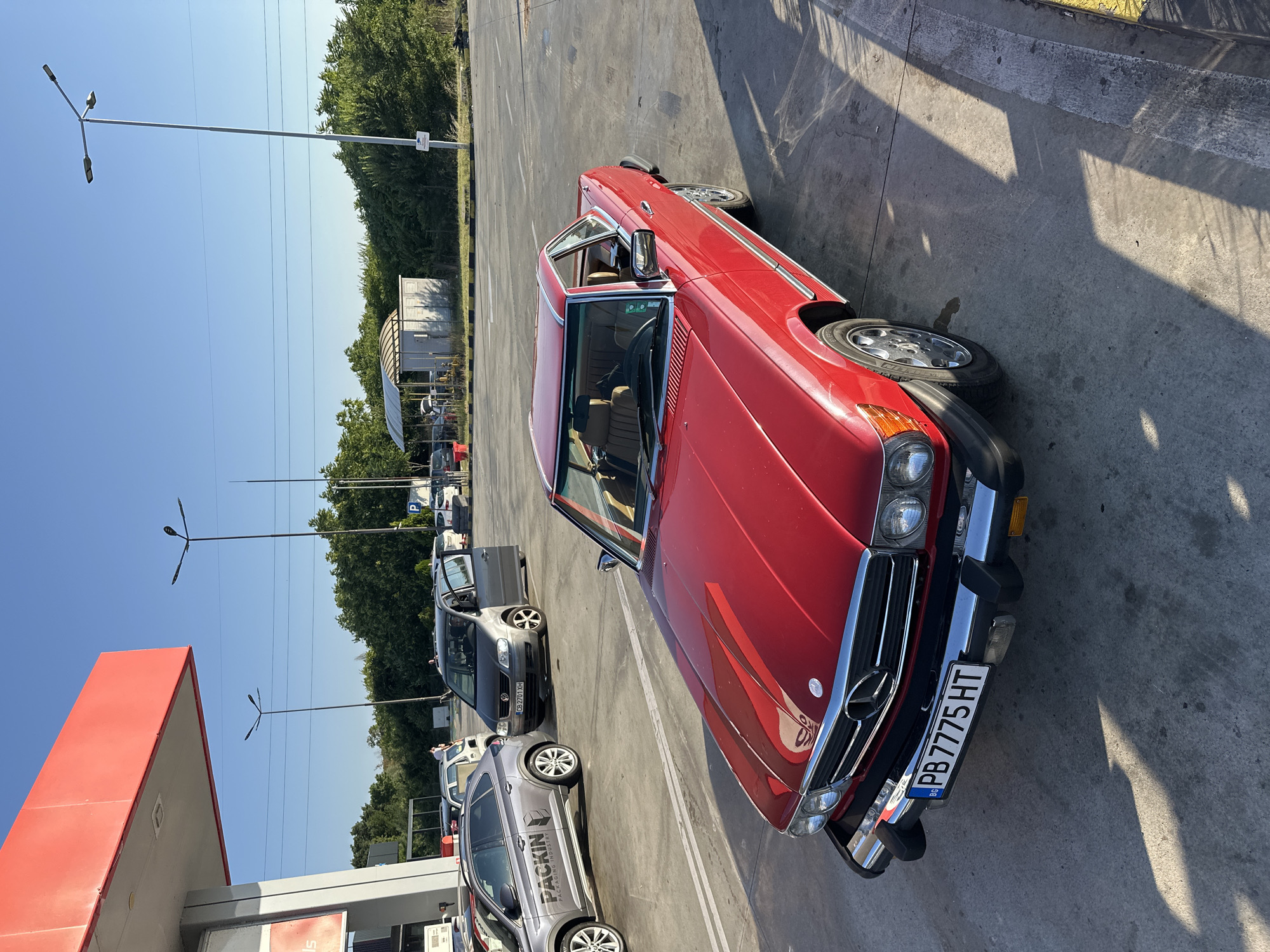 Classic Mercedes and three-wheeled motorcycle meet at Bulgarian gas station