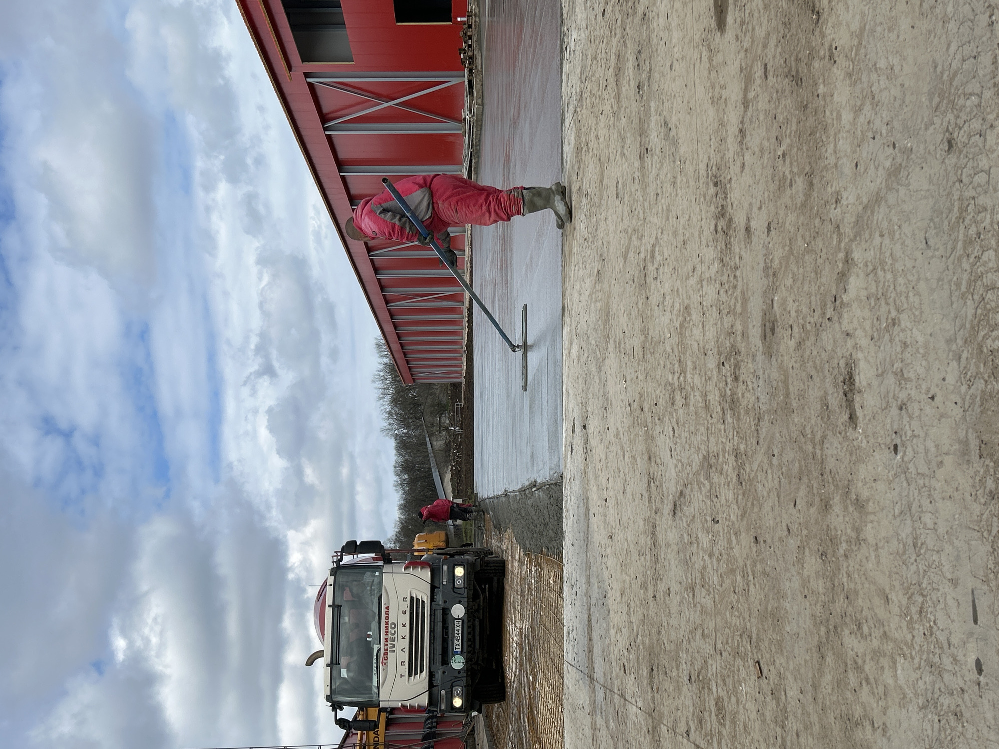 Construction worker smooths concrete slab in Donchevo, Bulgaria
