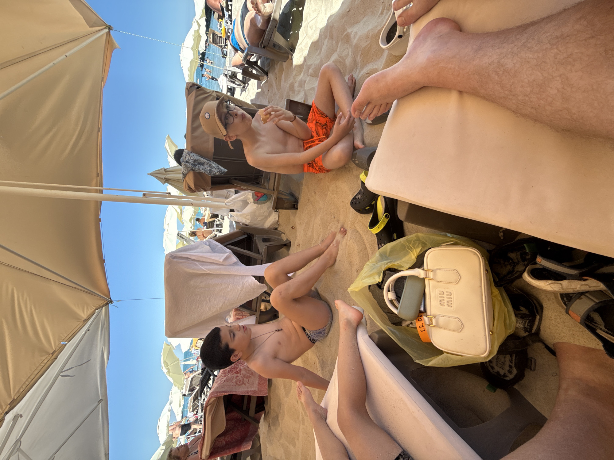 Lazy beach afternoon with kids, loungers, and tabletop items