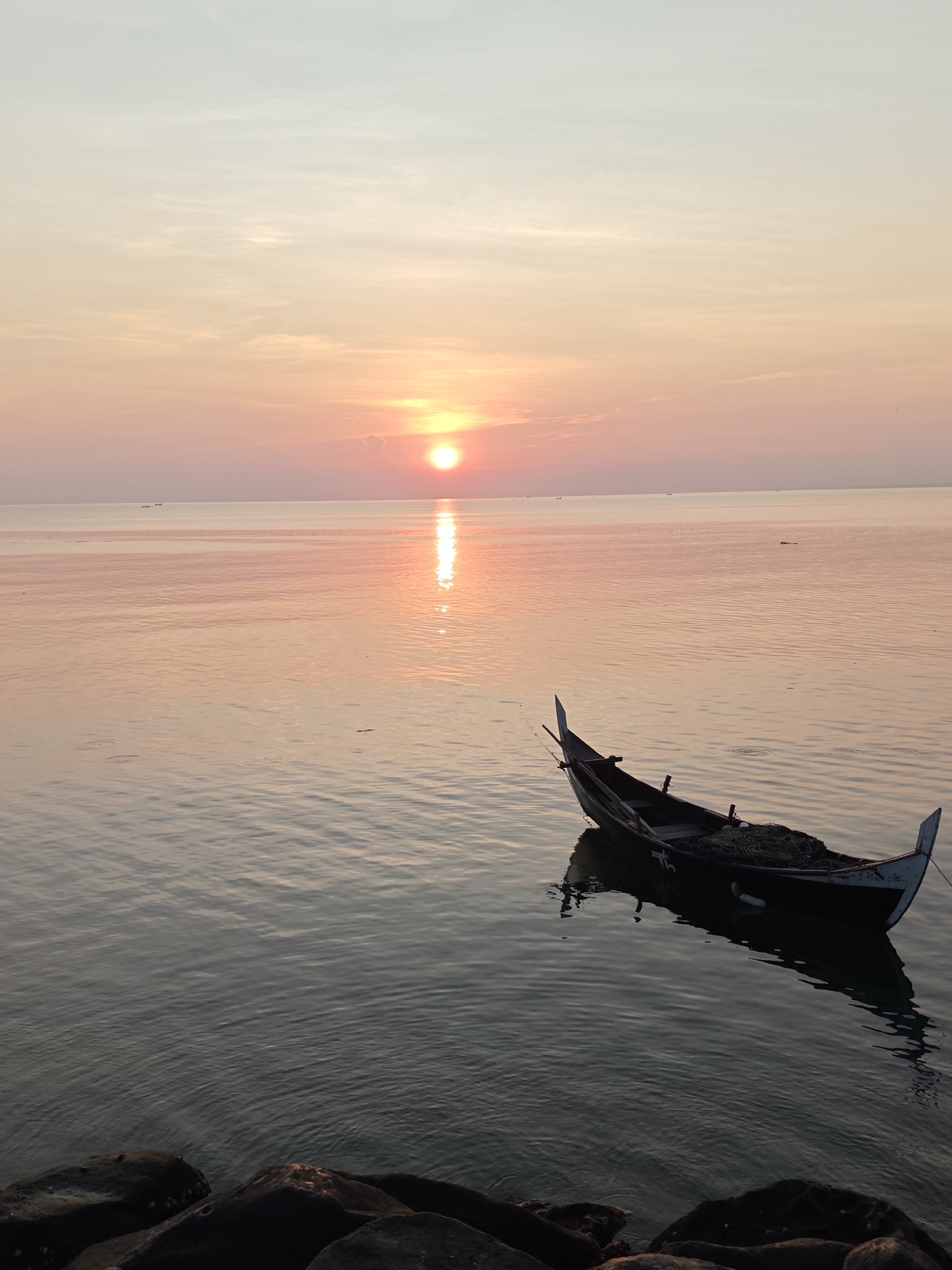 Sunset captured over calm waters in Lhokseumawe, Indonesia