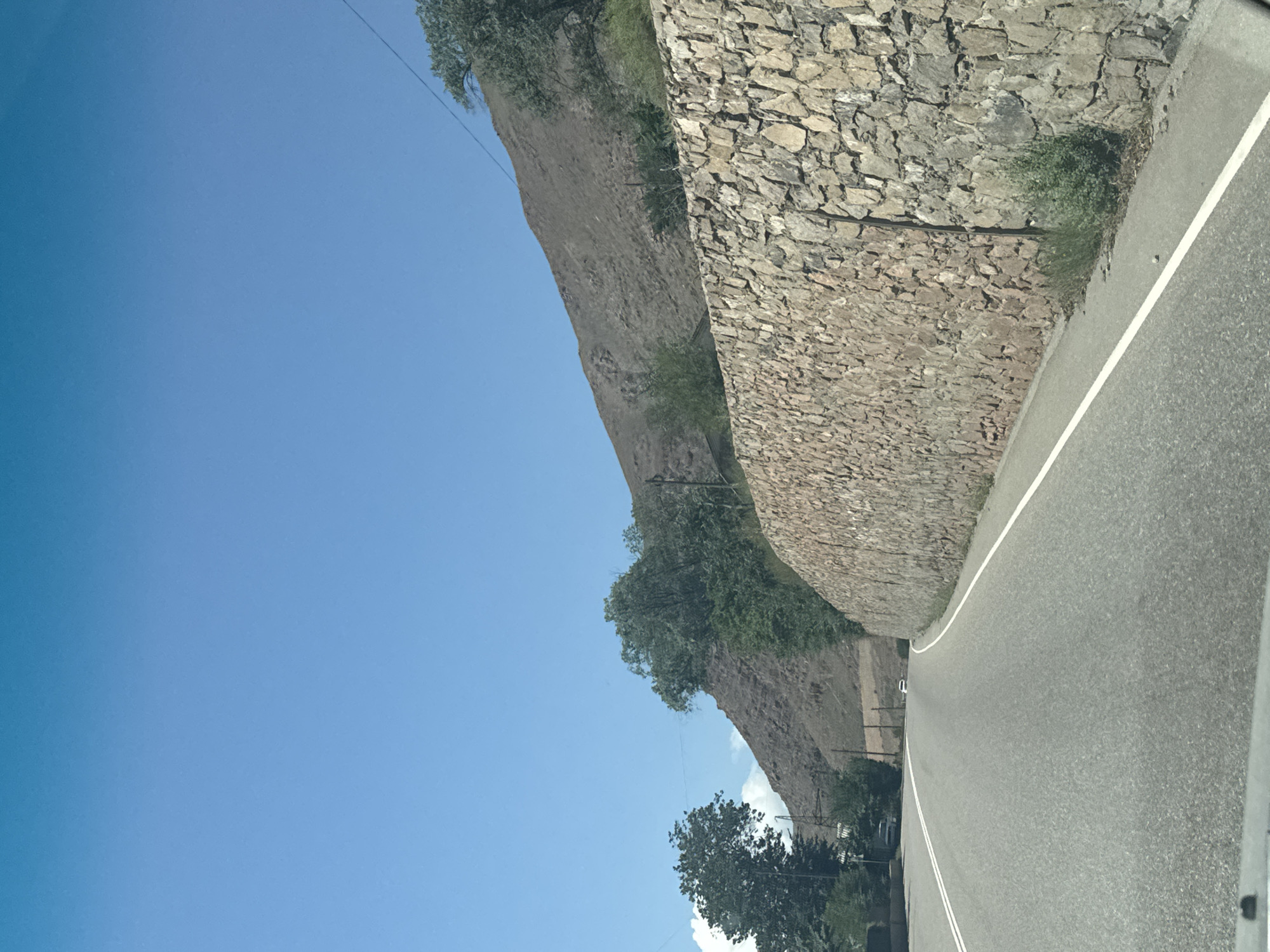 Mountain road and roadside details through Cholok, Kyrgyzstan