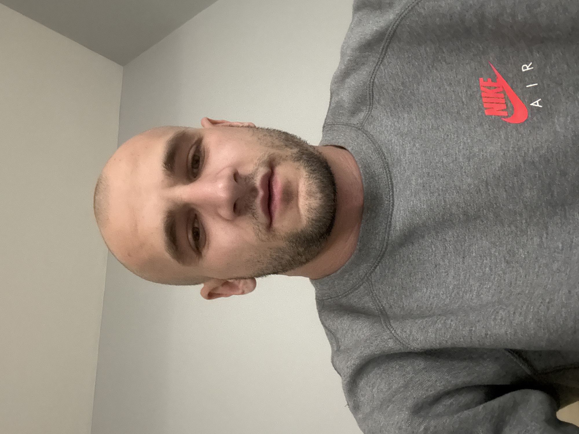 Man in Nike sweatshirt photographed indoors in Sofia