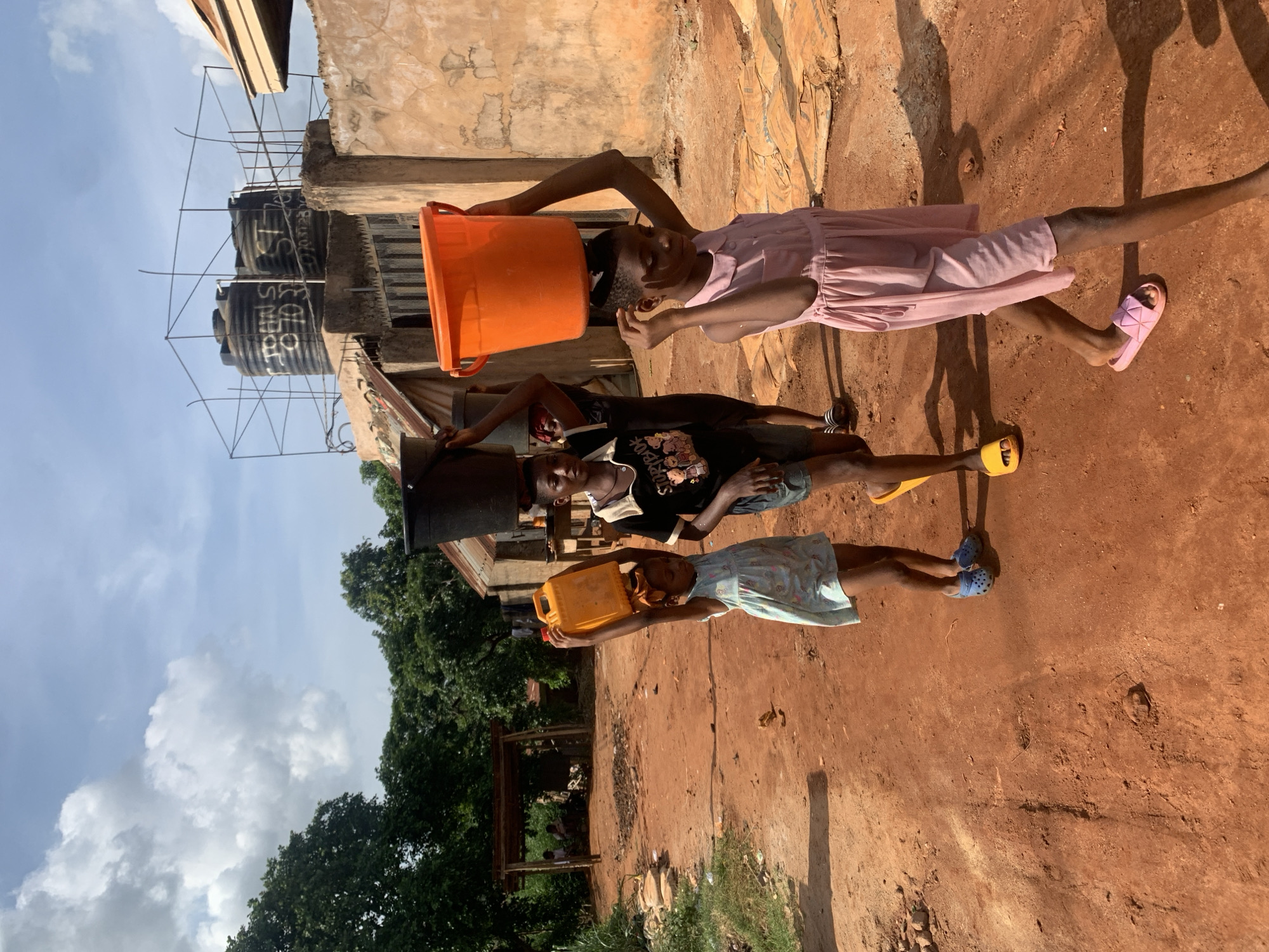 Children carry water containers in Ukwu-Abwa, Nigeria