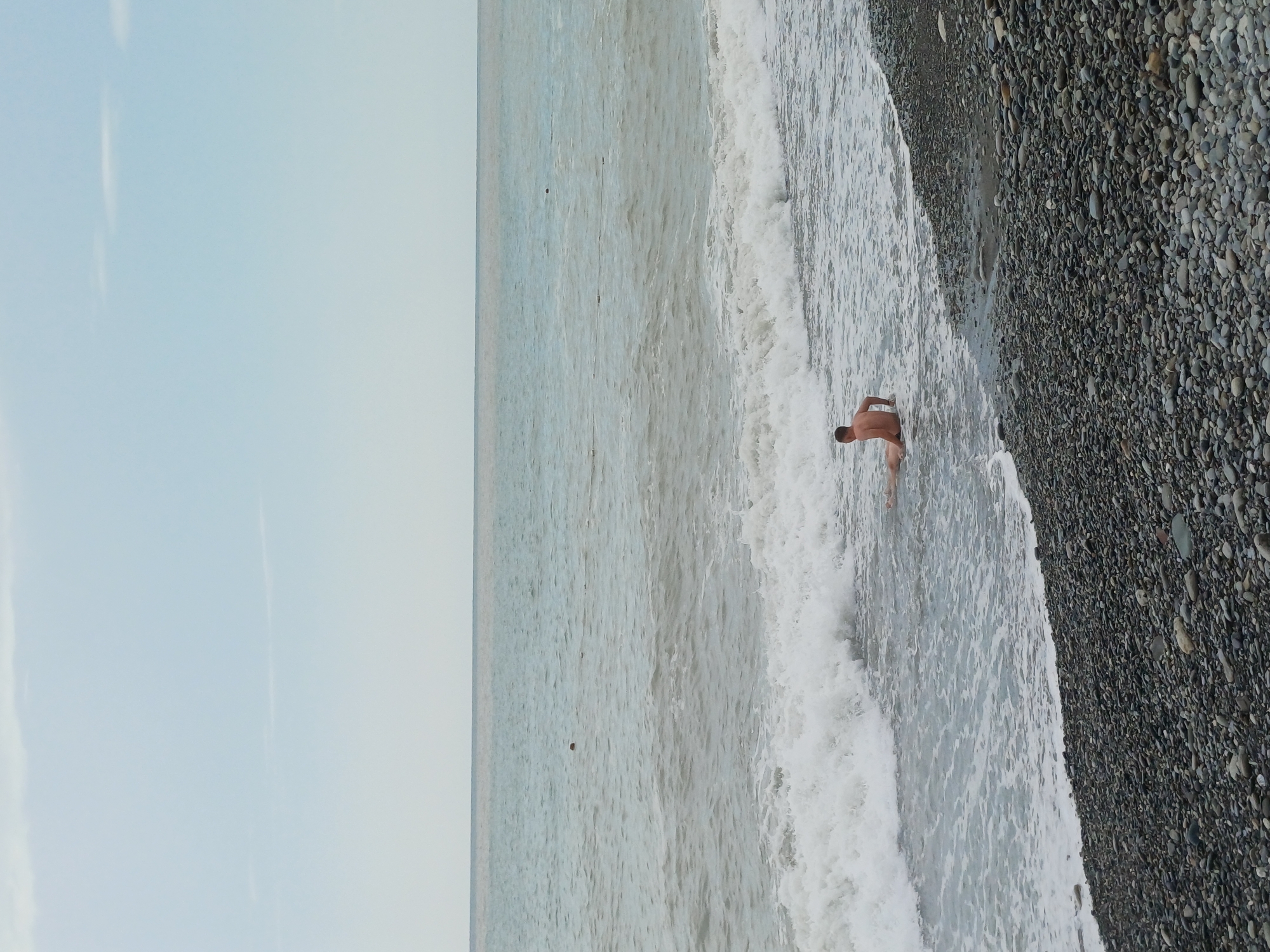 Quiet day on Sochi's pebble beach under overcast skies