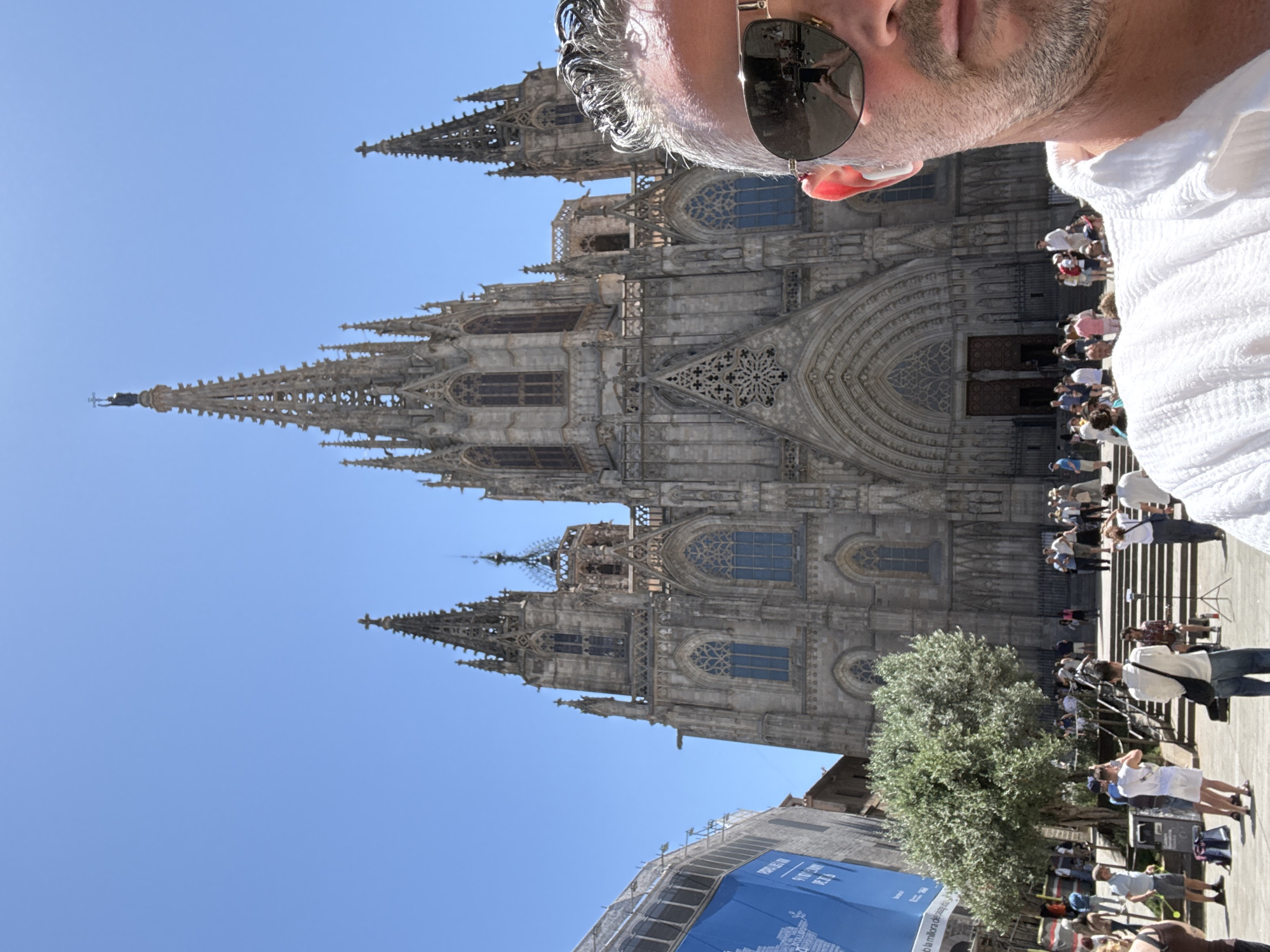 Tourist photographs Barcelona Cathedral on sunny morning