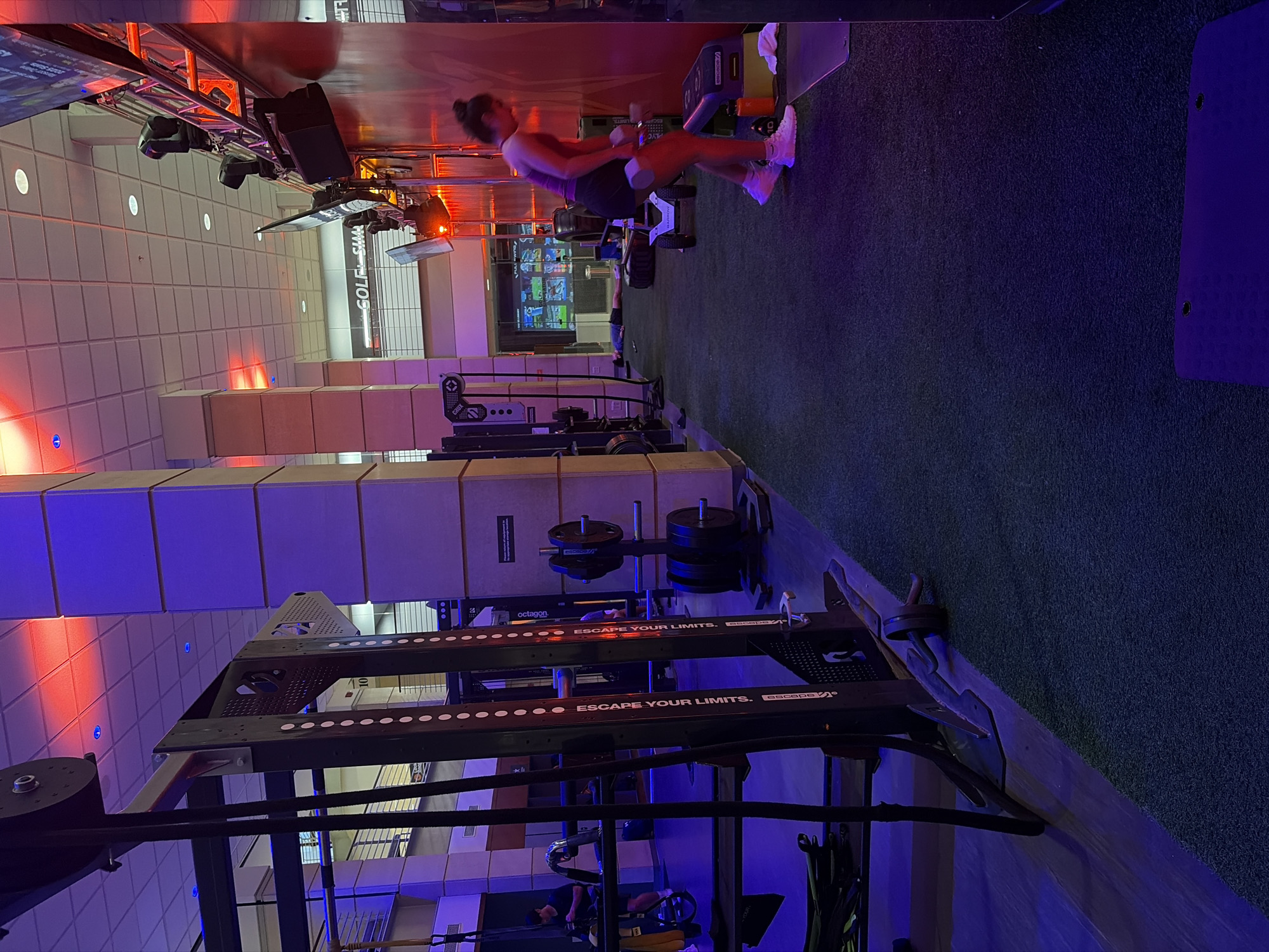 Woman exercises with weights at Austin gym late evening