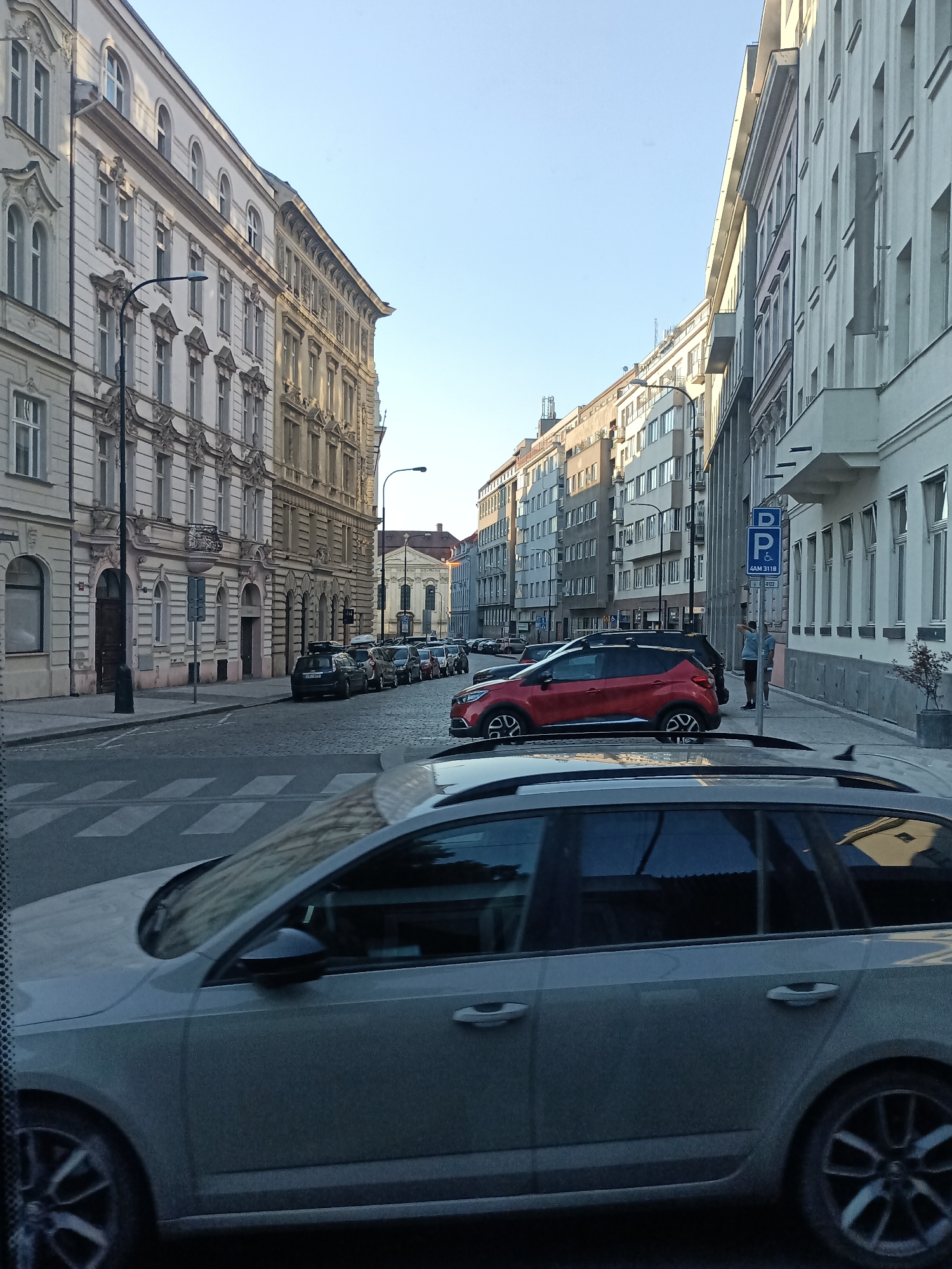 Prague's historic streets and church facades in late afternoon light