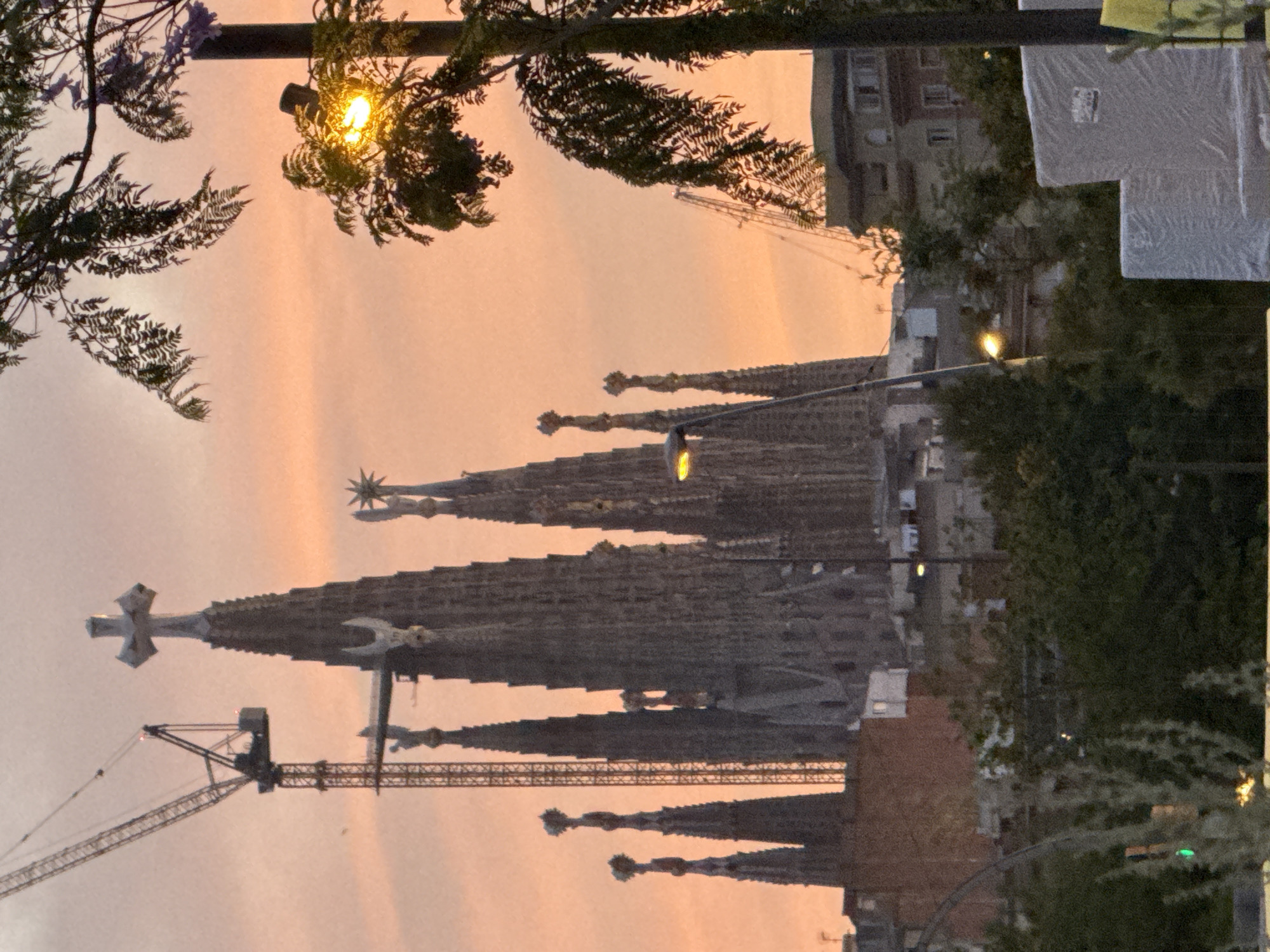 Barcelona evening stroll captures illuminated Torre Glòries at twilight