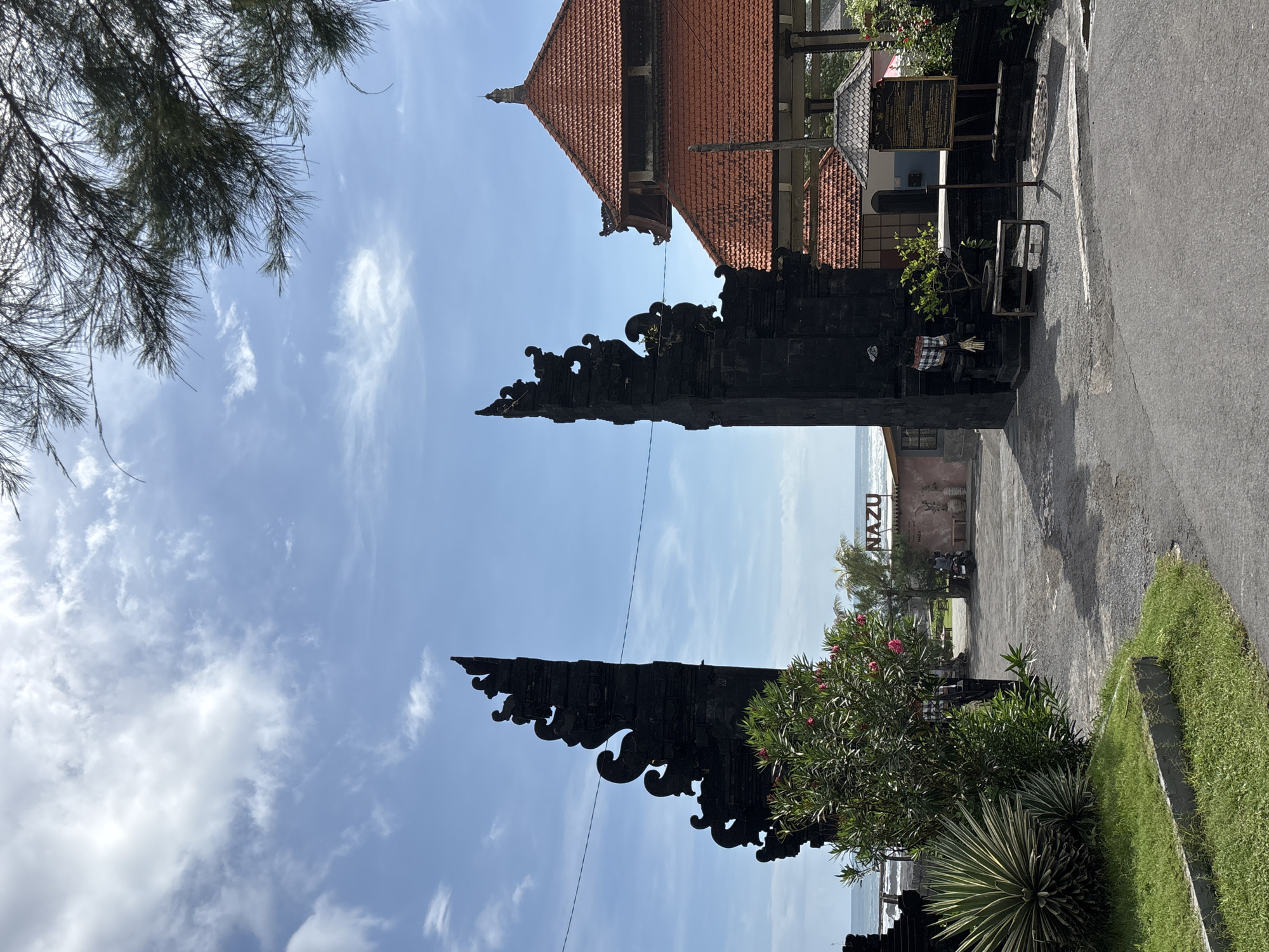 Morning scenes captured in Mengwi: traditional gate, roadside fruit stall