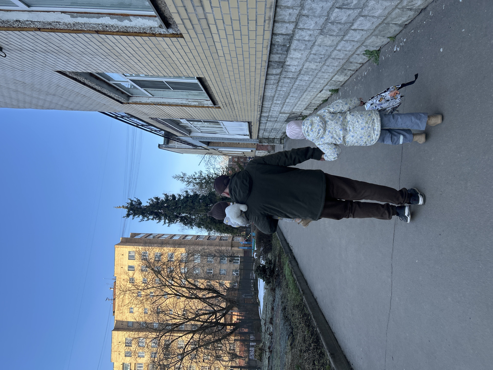 Family with young children documented during early morning outing in Klin