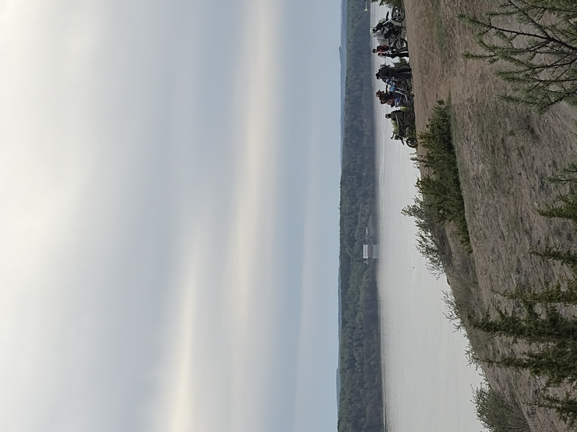 Motorcycle group rides hills near river in Ольховка, Russia