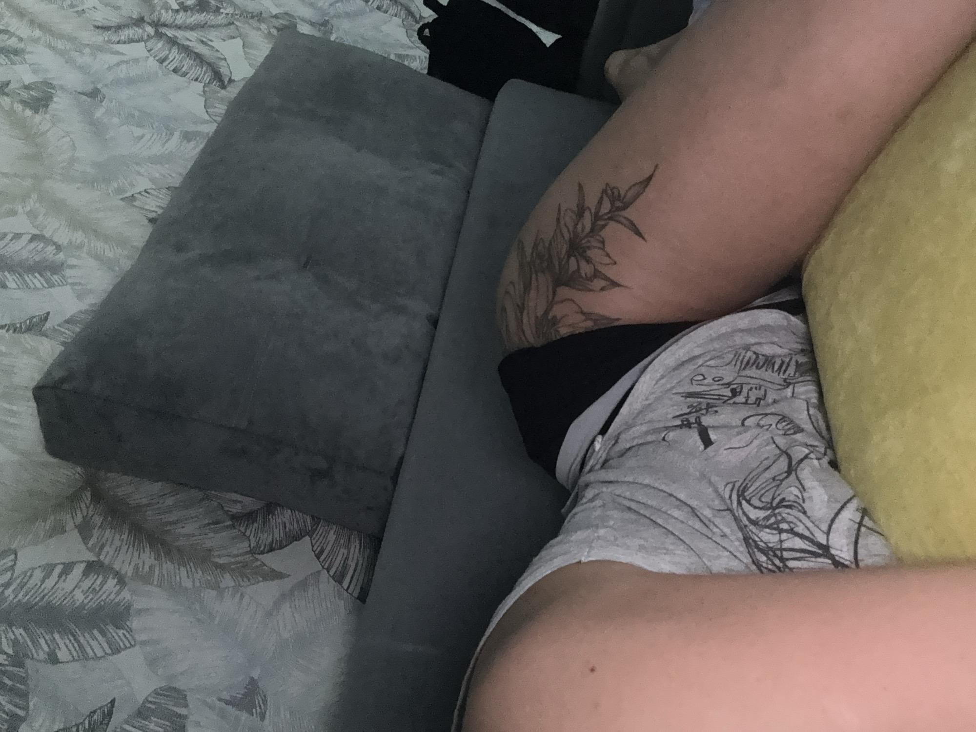 Person watches TV on sofa during evening in Russia