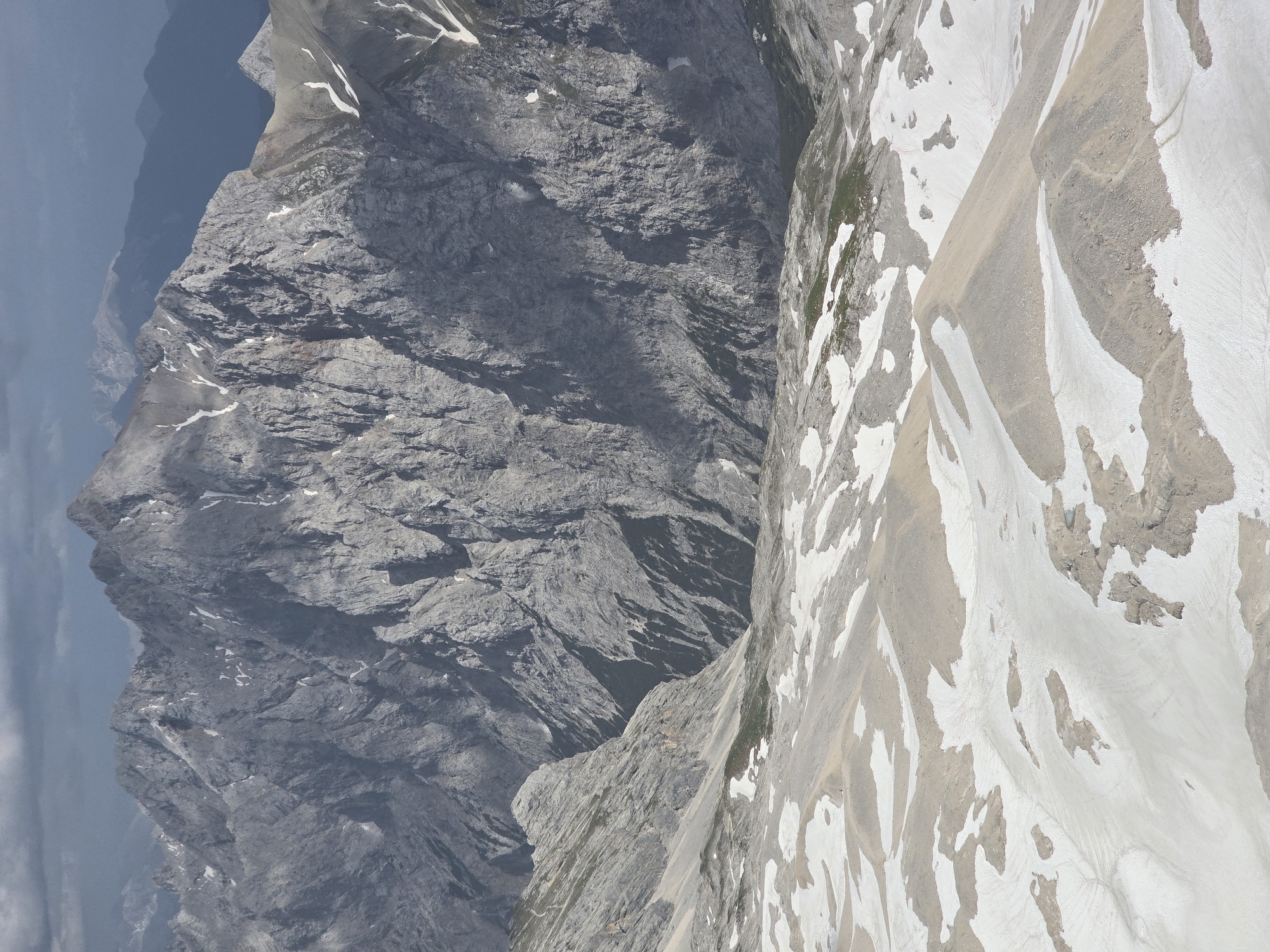 Aerial views over the rocky, snow-dusted Zugspitze range