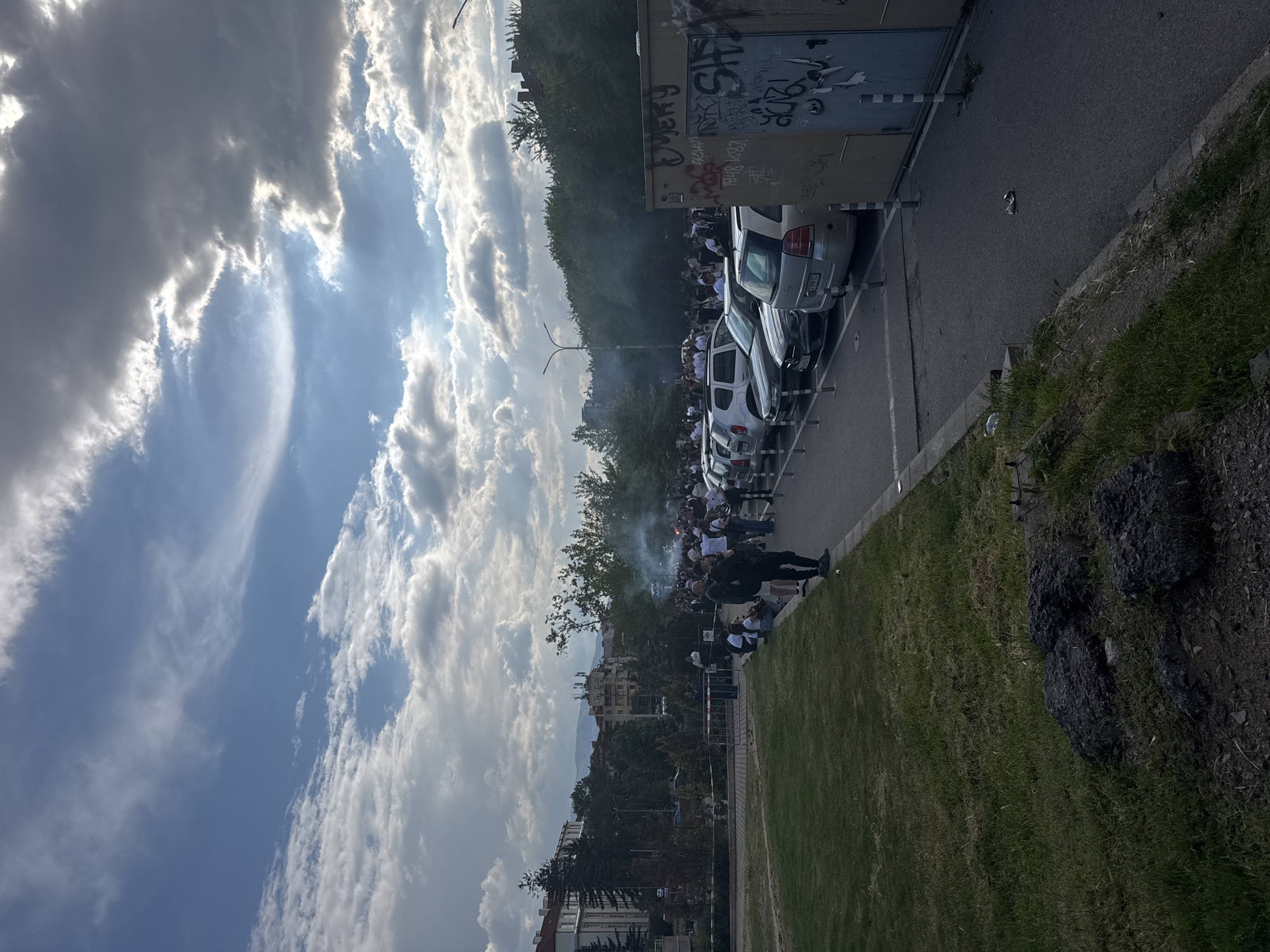Crowd gathers on Sofia street, smoke visible
