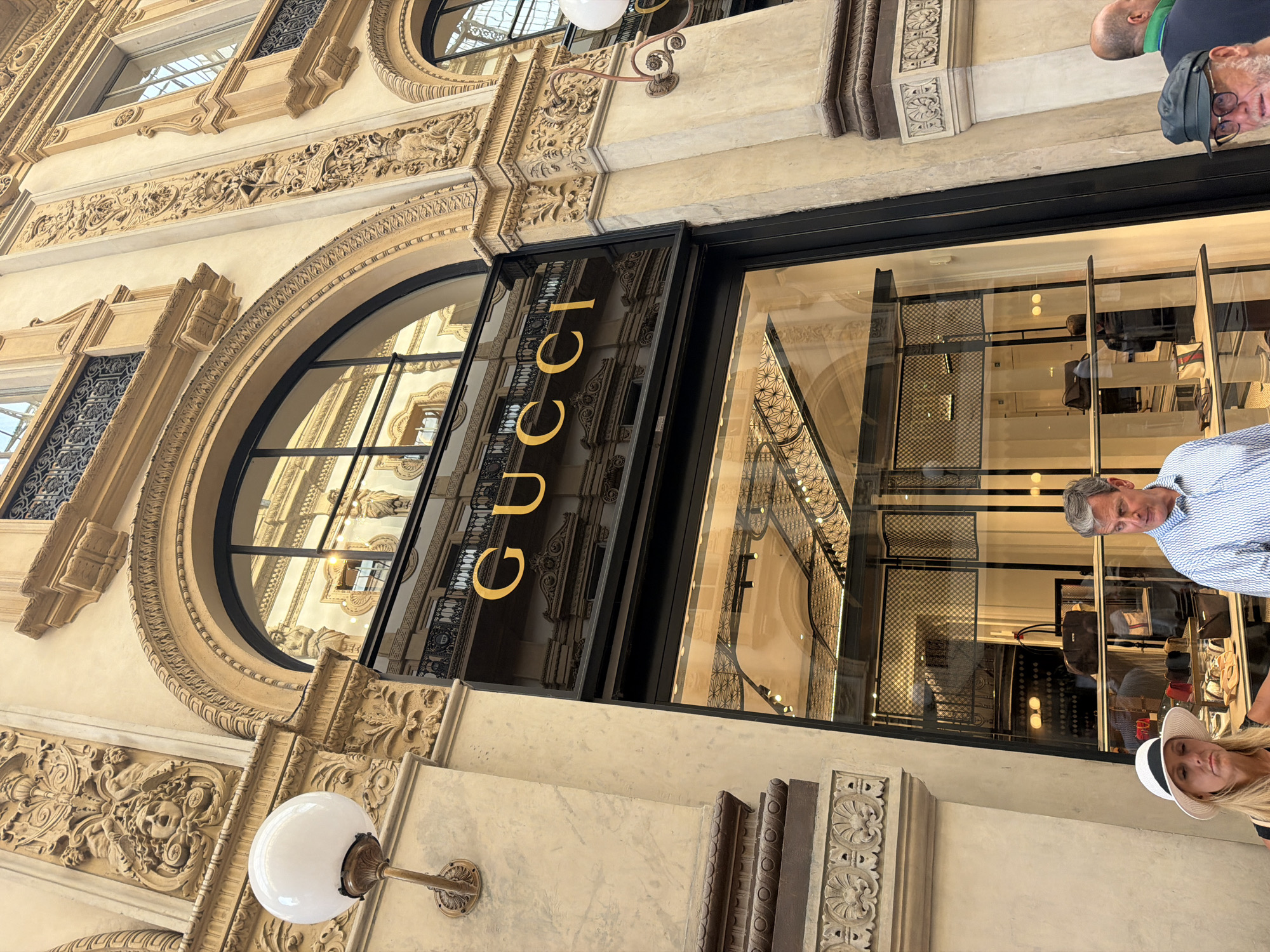 Tourist documents luxury shopping district in Milan's historic Galleria