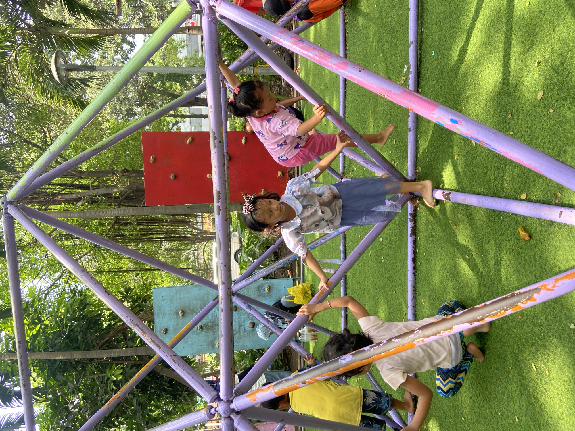 Children play at Surabaya playground, some in traditional costumes