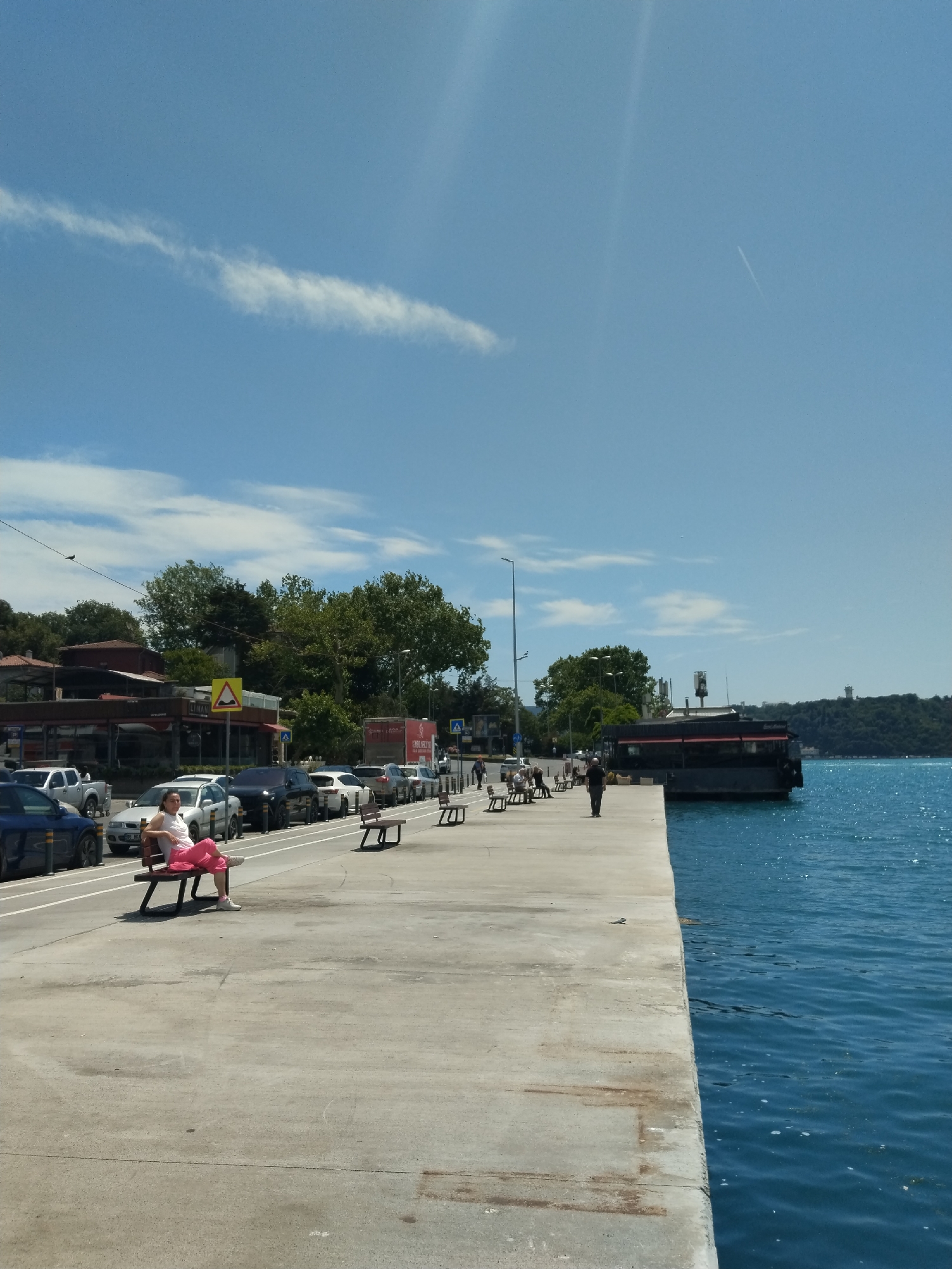 Clear morning at Sarıyer marina shows luxury boats, sunny skies