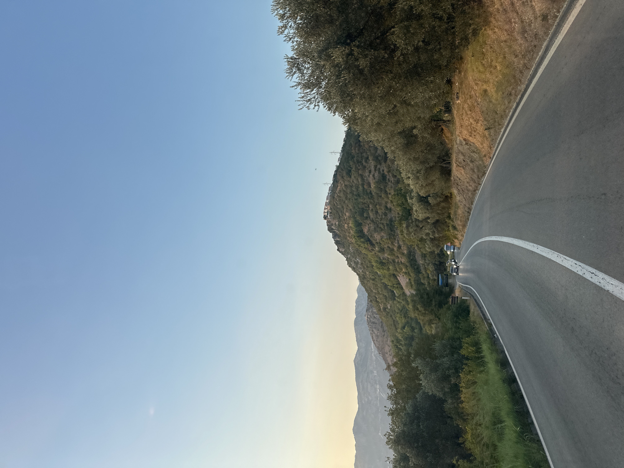 Coastal road drive through Sveti Stefan at golden hour