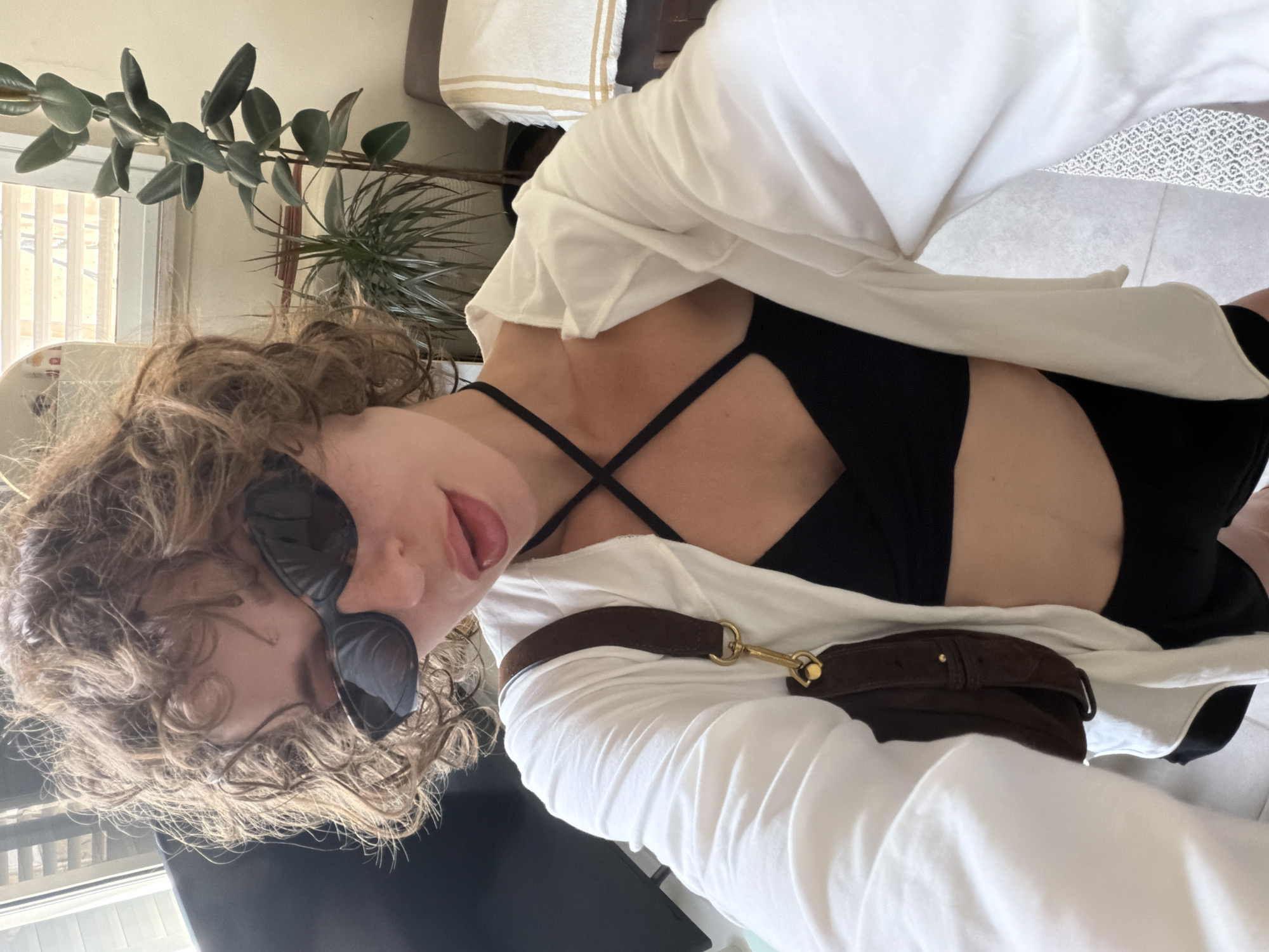 Indoor selfie moment in Tel Aviv with greenery in the background