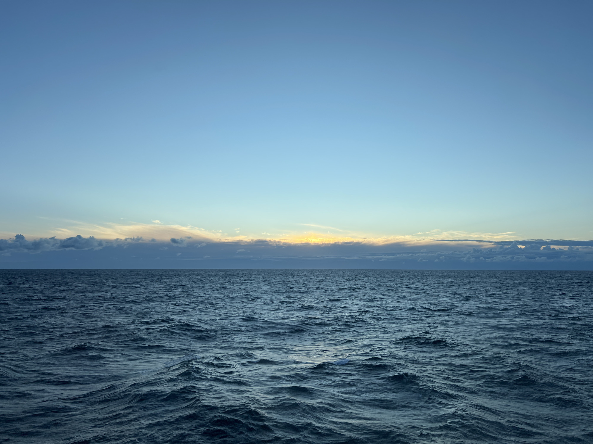 Open Baltic waters at dawn, clouds glowing on the horizon