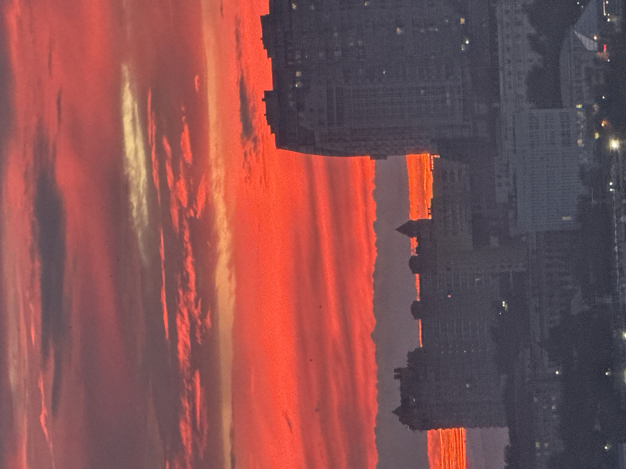Vladivostok harbor glows red at sunset, port traffic rolling