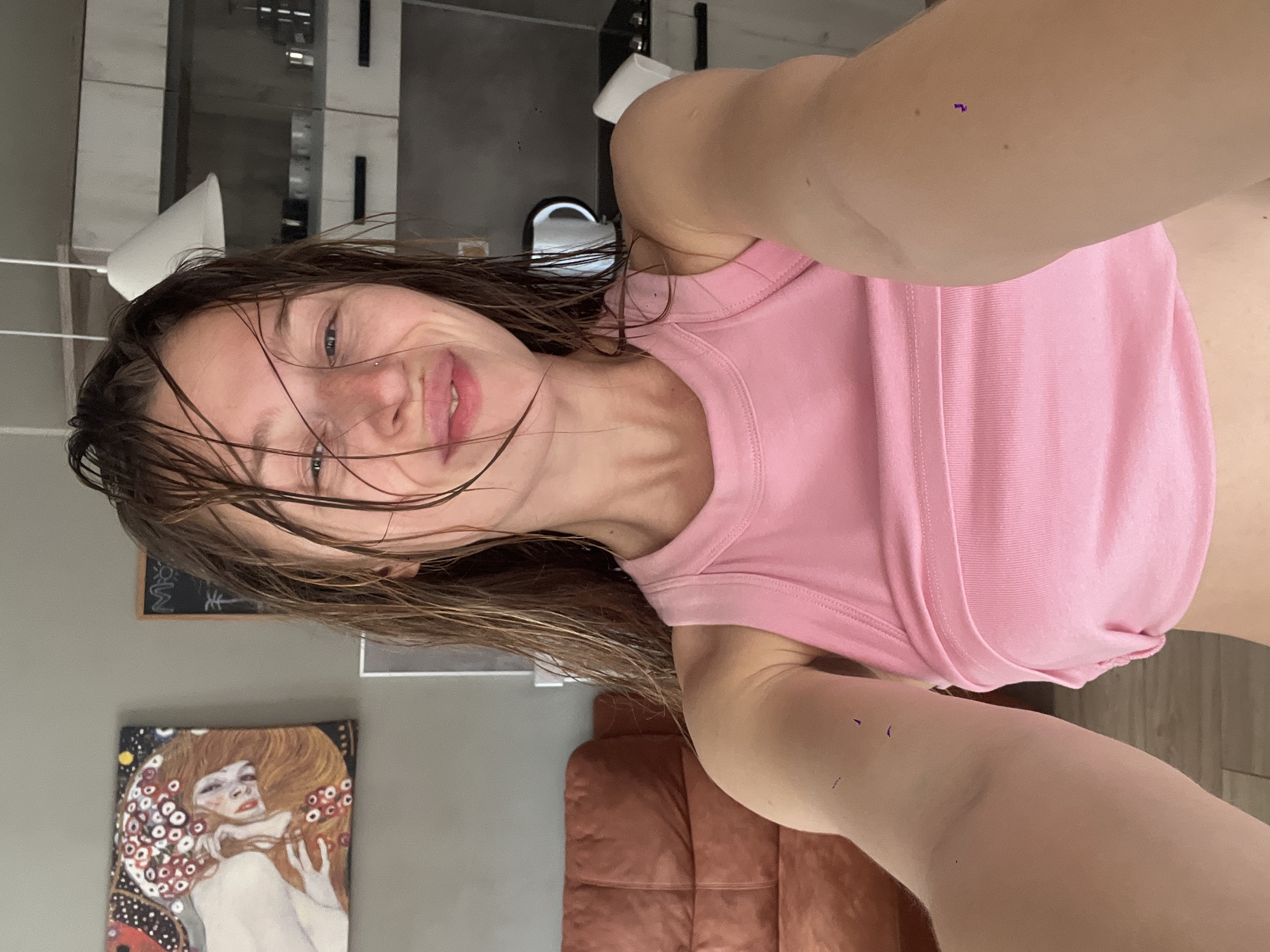 Woman with wet hair photographed from low angle in Bečići