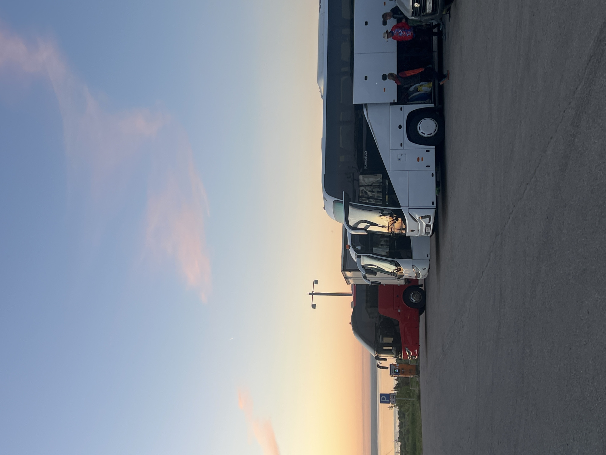 Buses park at Khvalynsk rest stop during sunset