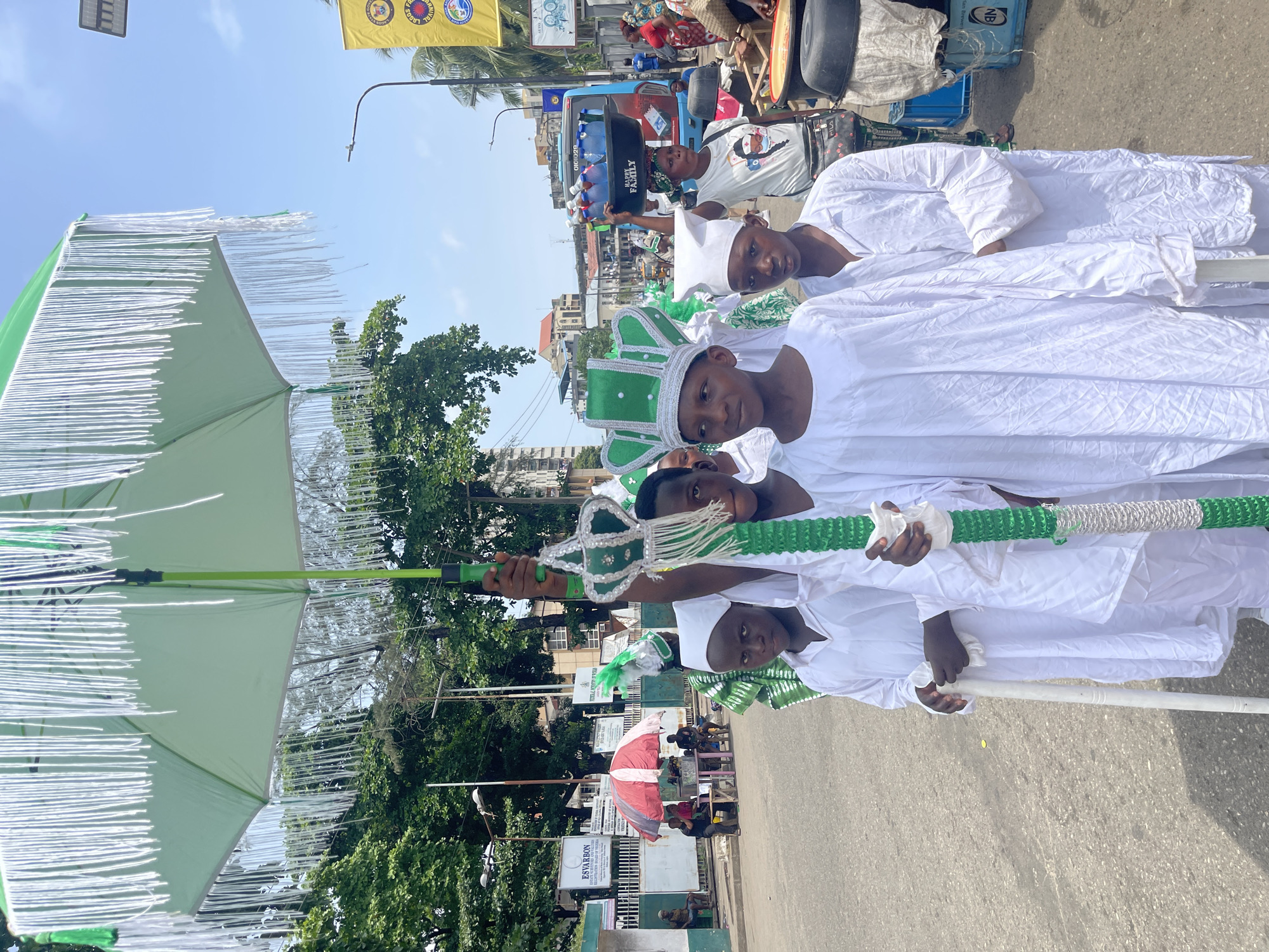 Children in ceremonial dress parade through Lagos streets