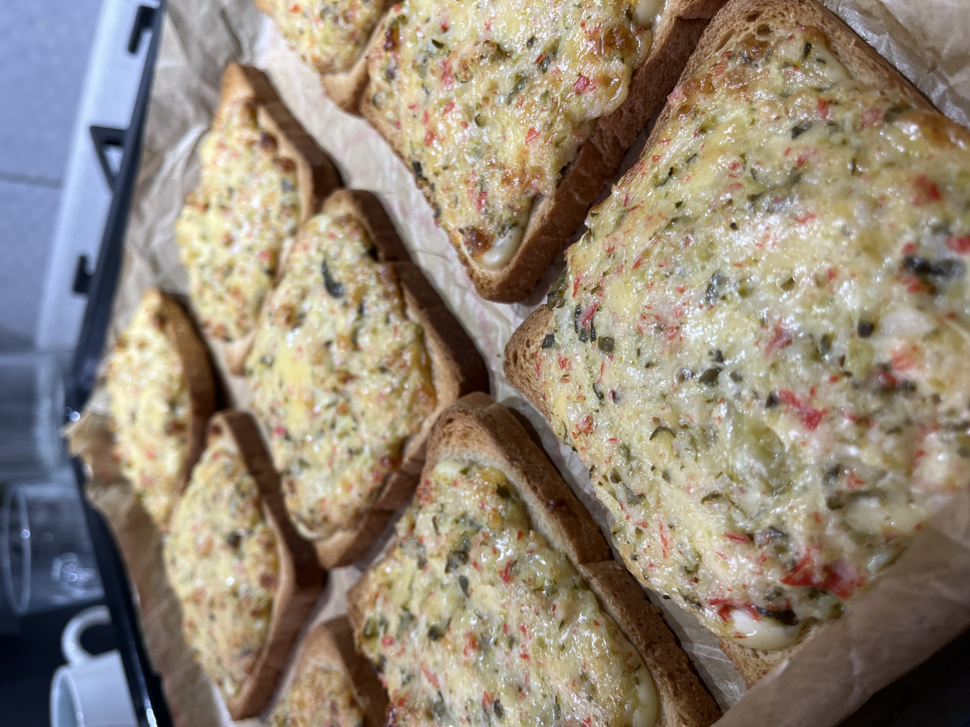 Cheesy toast on a baking sheet, fresh from the oven