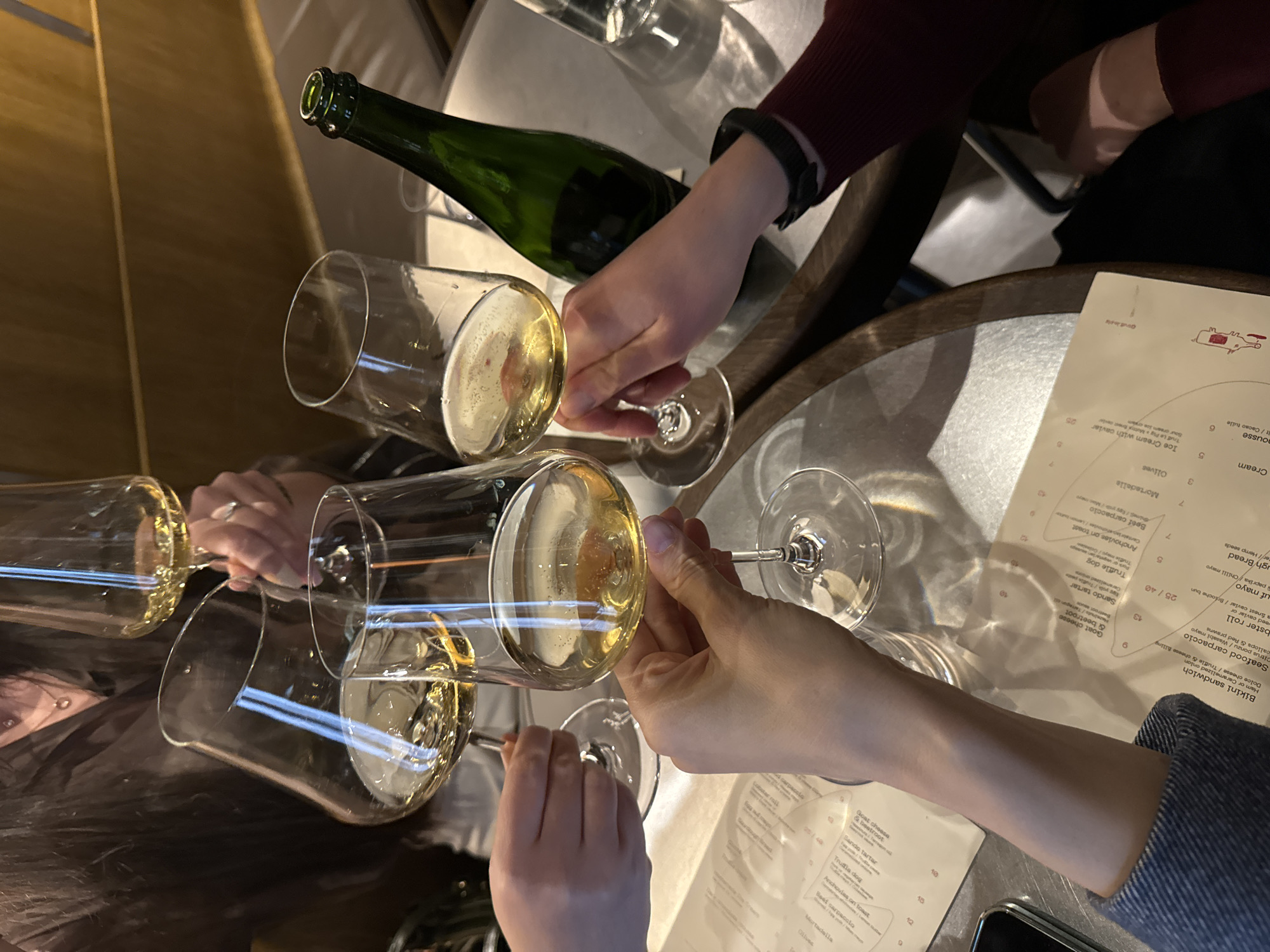 Friends celebrate with sparkling wine at Riga restaurant