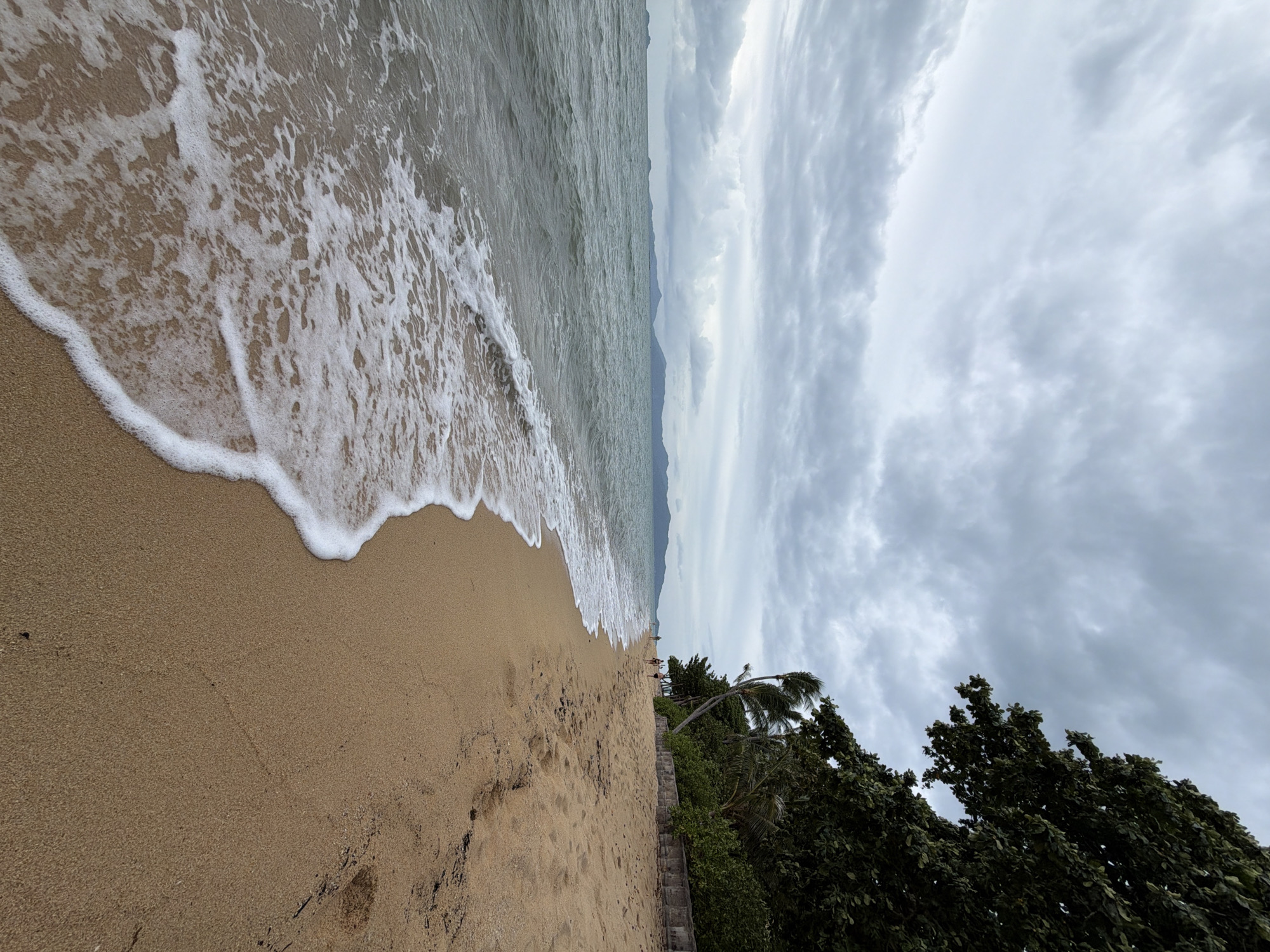 Wing foiling and coastal activity off Ko Samui on an overcast morning