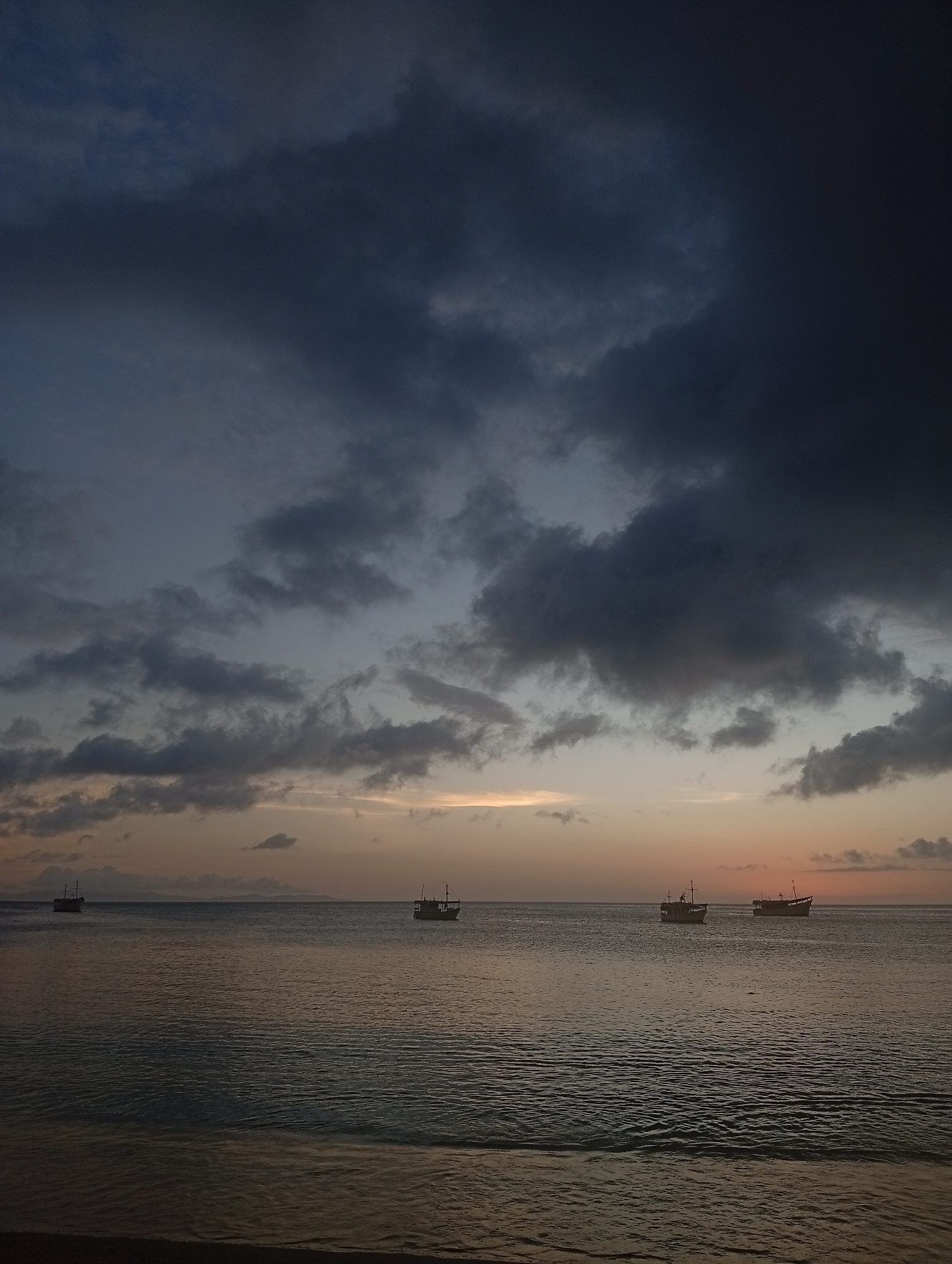 Sunset at the beach, boats on water, casual evening vibes