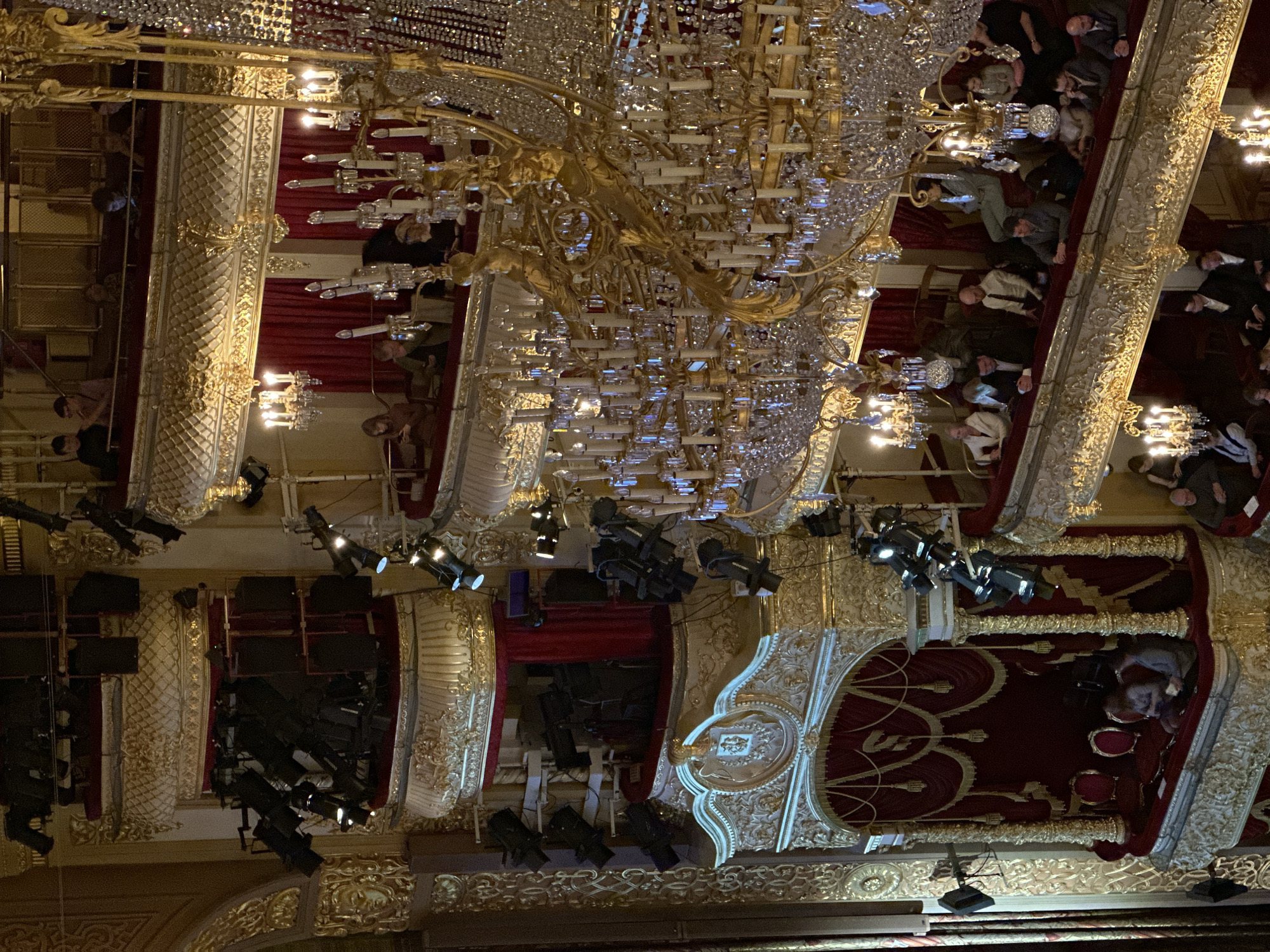 Theater audience gathers under ornate chandelier in Khimki