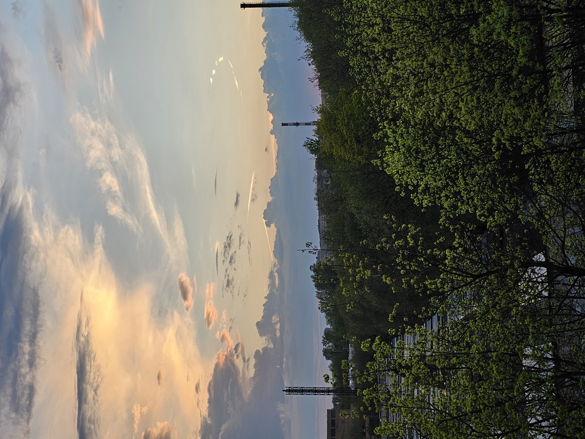 Dramatic sunset with light rays photographed over Moscow industrial area