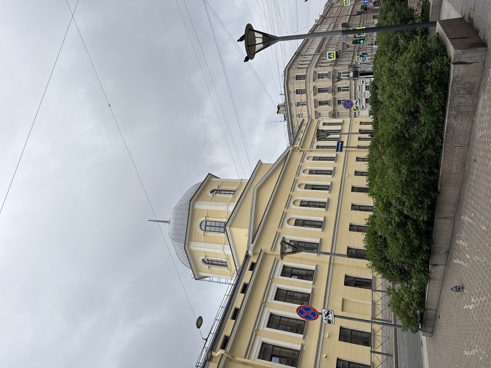 Classic yellow architecture and a dome on a cloudy Saint Petersburg street