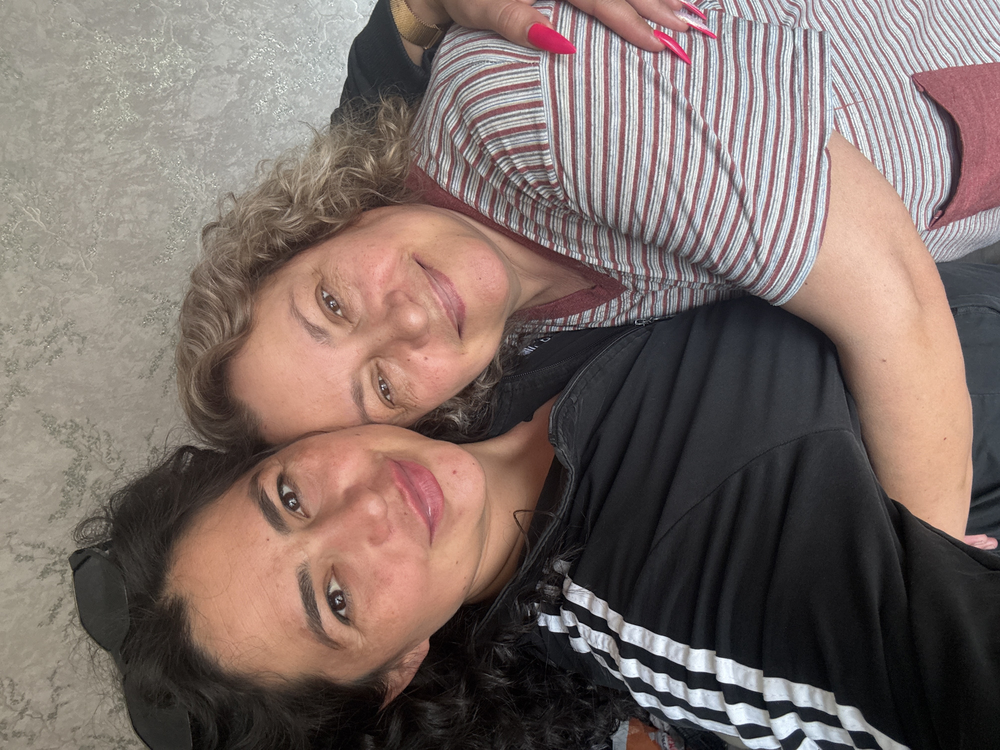 Two women rest together on couch in Кемуль