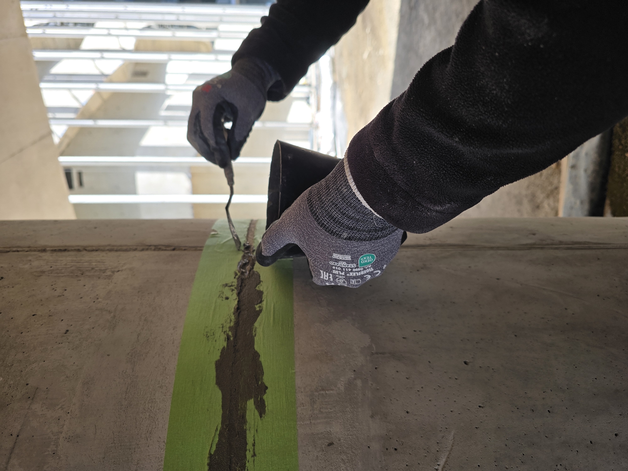 Construction workers repair concrete pillars in Ramat HaSharon