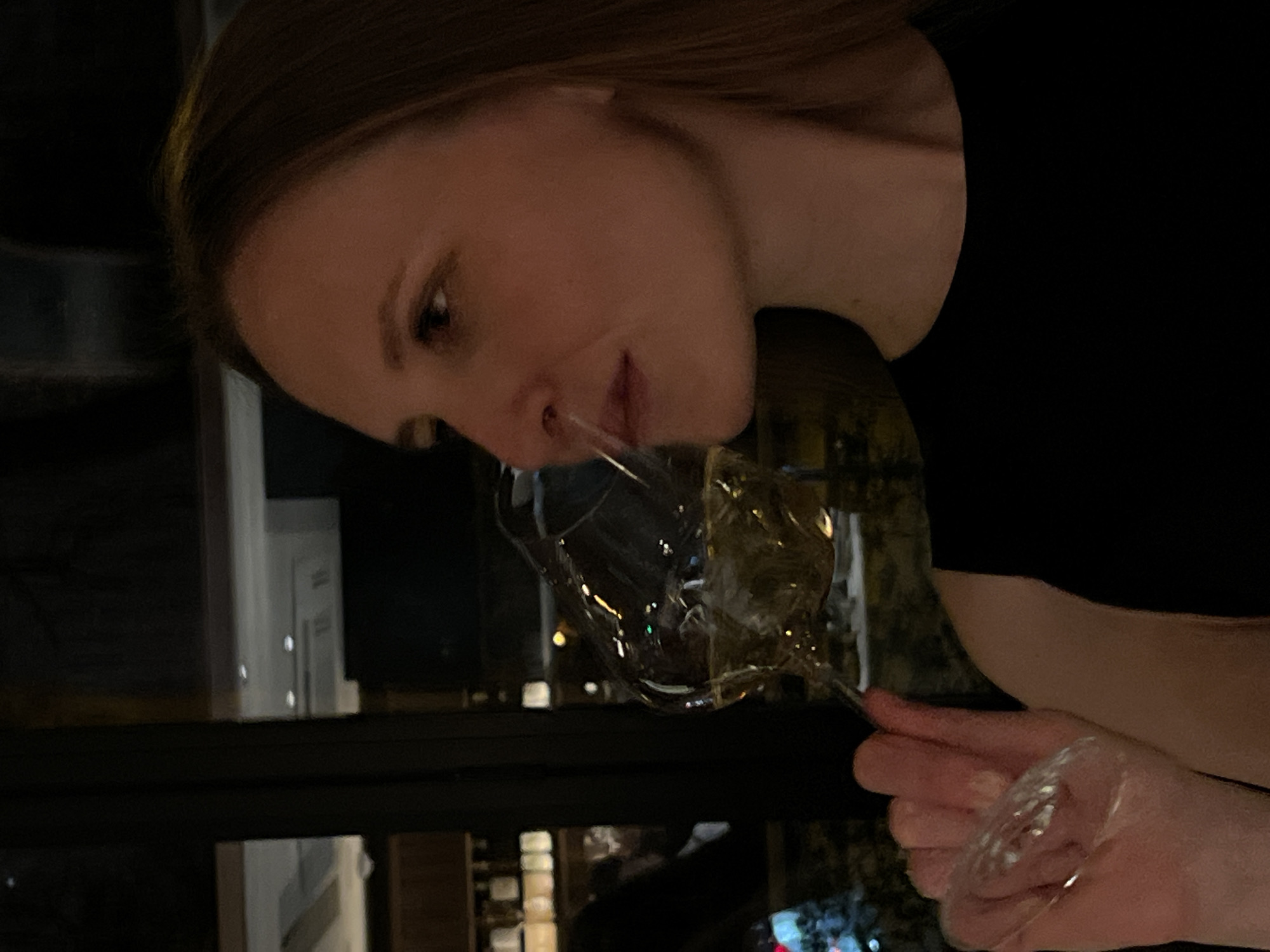 Woman enjoys wine at upscale restaurant Friday evening