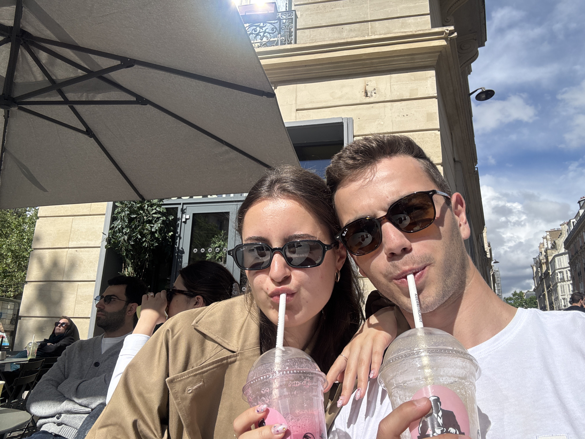 Young couple captures selfie moment while drinking in Paris