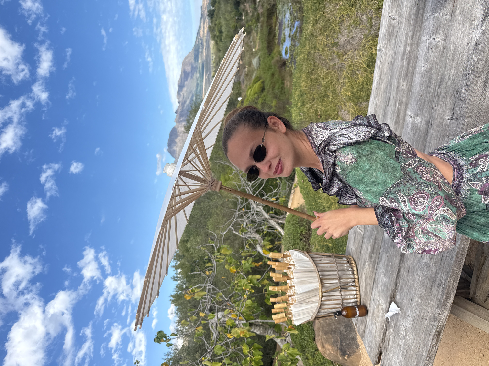 Woman with parasols visits sculptured gardens in Stellenbosch